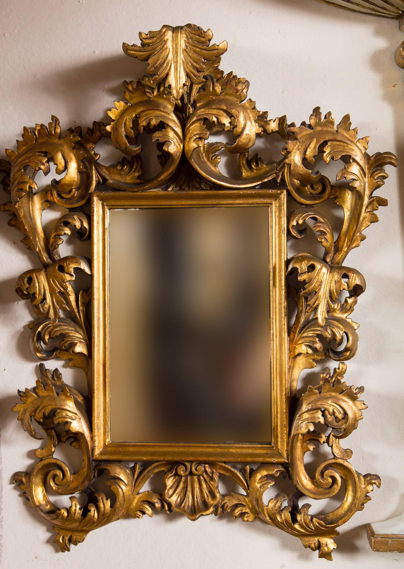 In the Rococo style, from the late 19th century, this Italian made mirror is deeply carved with leaves and scrolls.

 