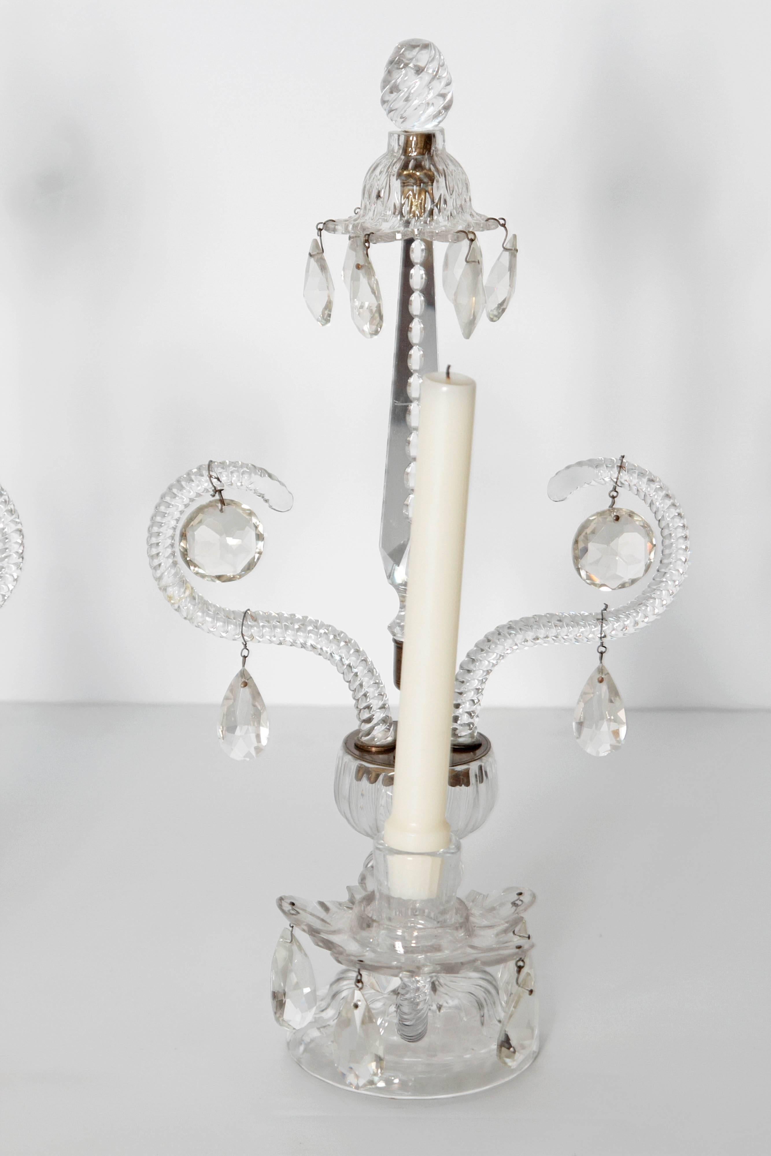 pair of Georgian / period George II cut-glass girandoles / lustres composed of a round base with two scrolling arms with suspended prisms, a central finial topped by a 
