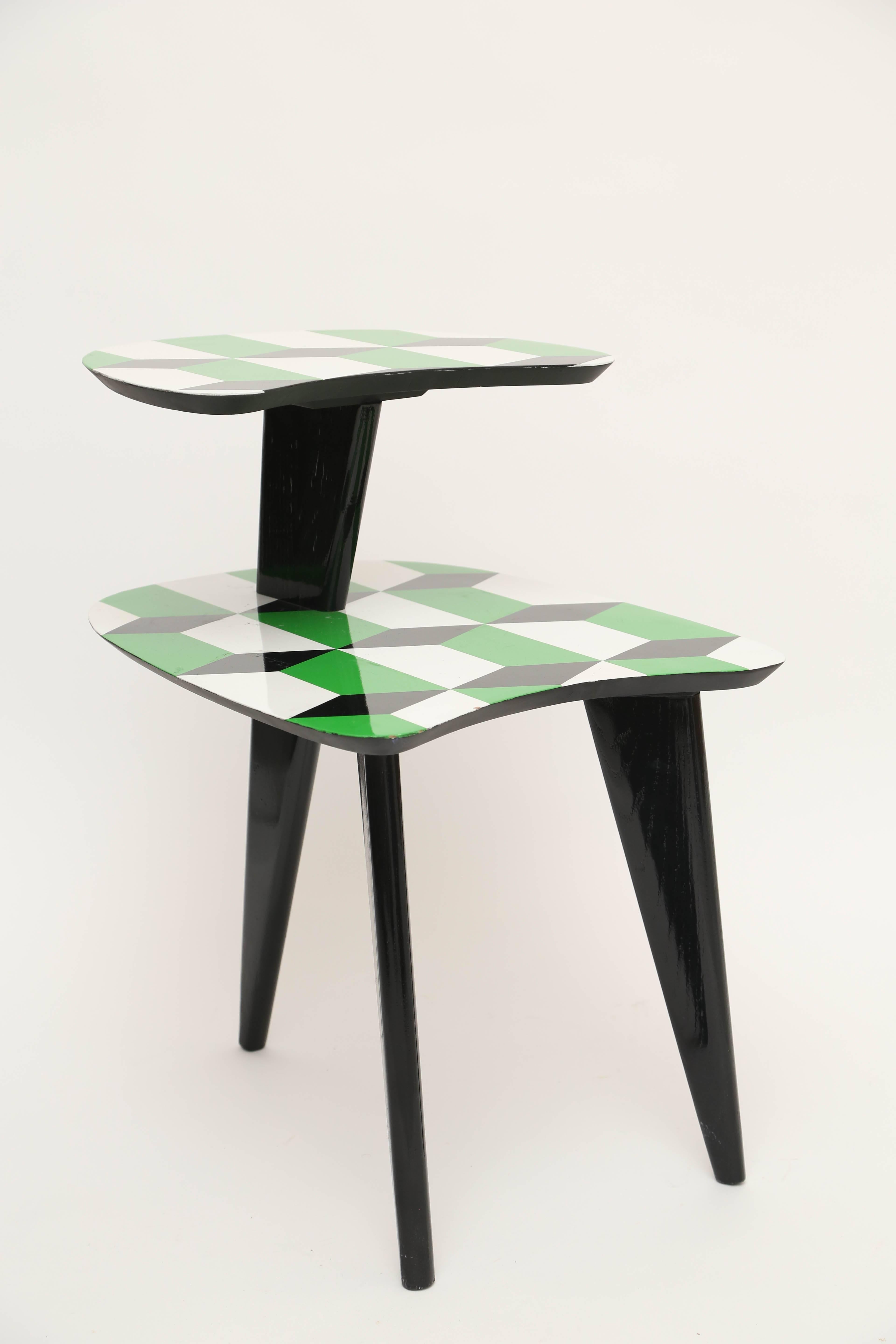 Pair of 1950s vintage tables with custom Gio Ponti style pattern high gloss in lacquer with solid black angular three legs.
