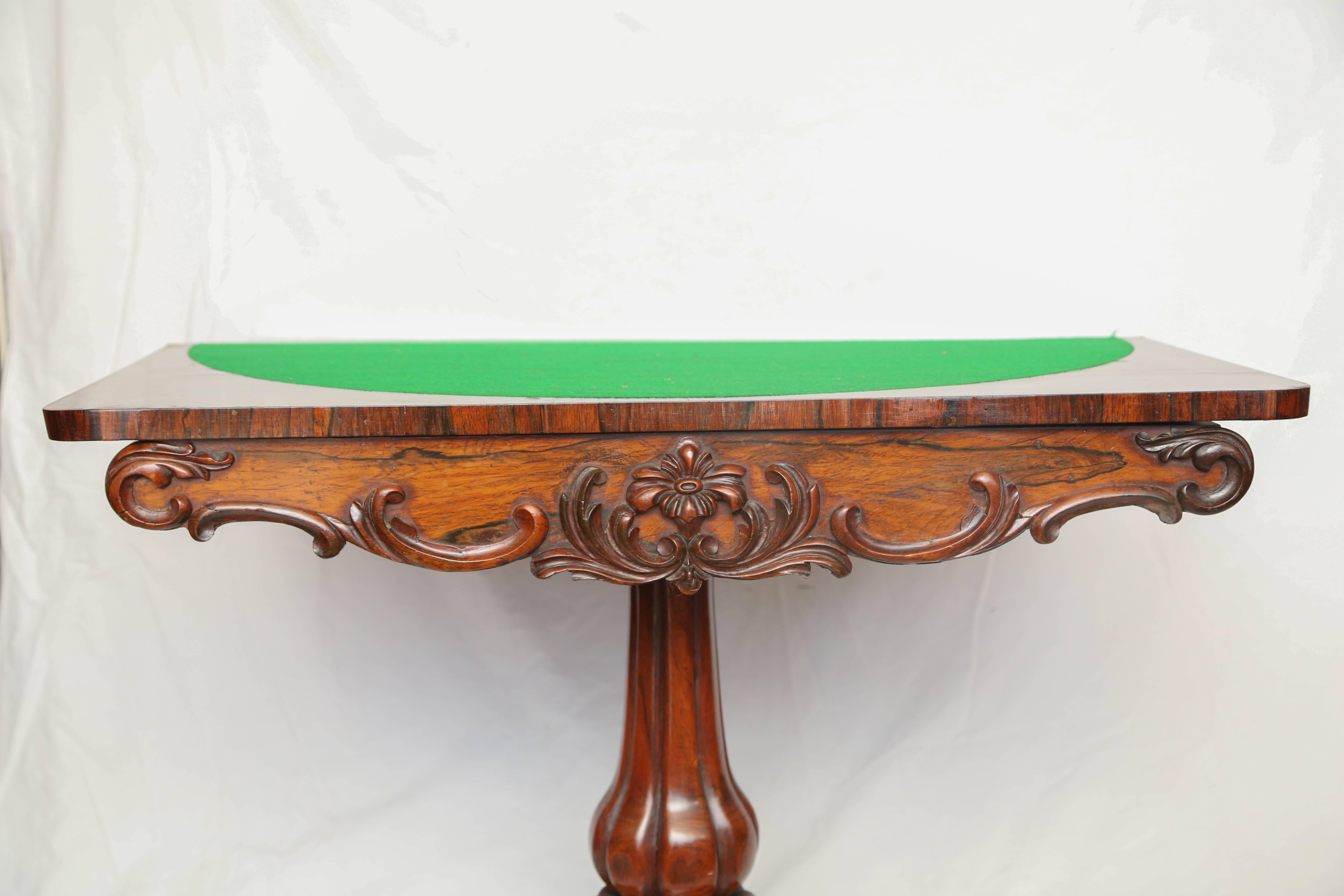 This is a very nice original fine quality rosewood game table with the original patina.
The base has lion paw feet with a large bulbous center pedestal.
To the top it opens out with the green baize to the center.
Superb quality carved freeze to the