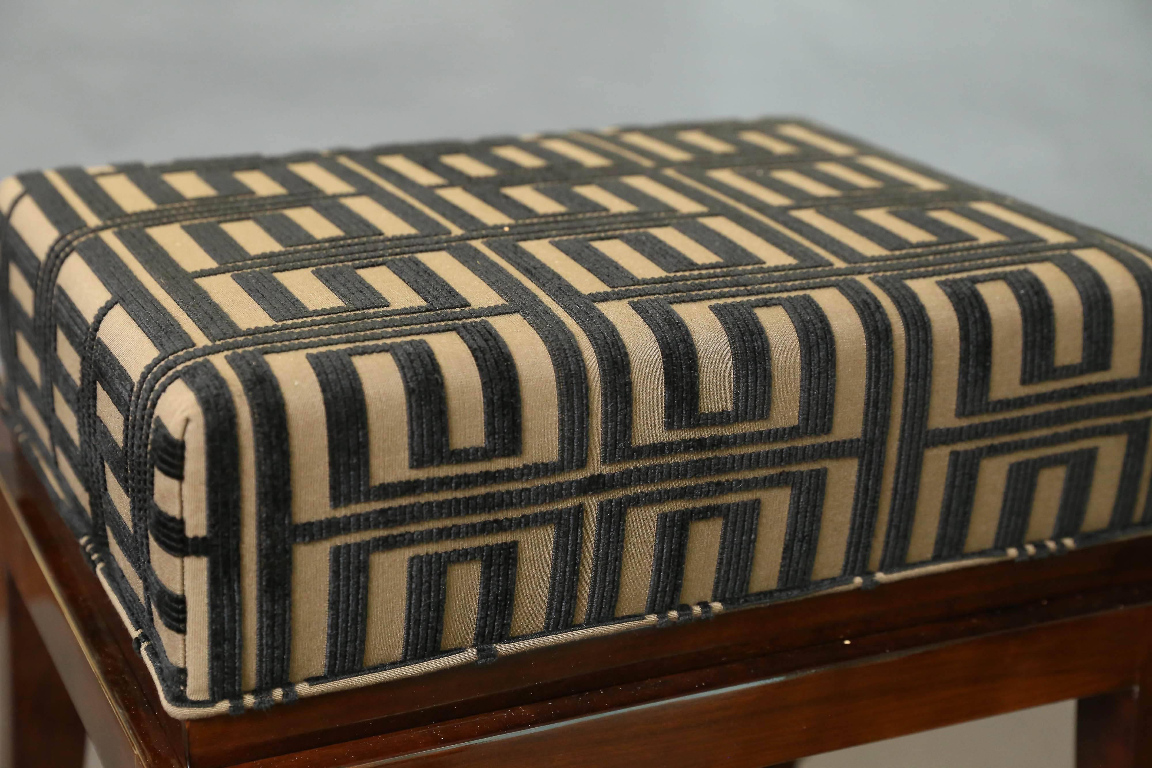 Ottoman is made out of walnut wood. The seat is newly re-upholstered with grey fabric with black geometric pattern. Ottoman is elevated by four elongated slightly curved wooden legs.


 France, circa 1930s

 Measure: 19” W x 14” D x 19” H.
 