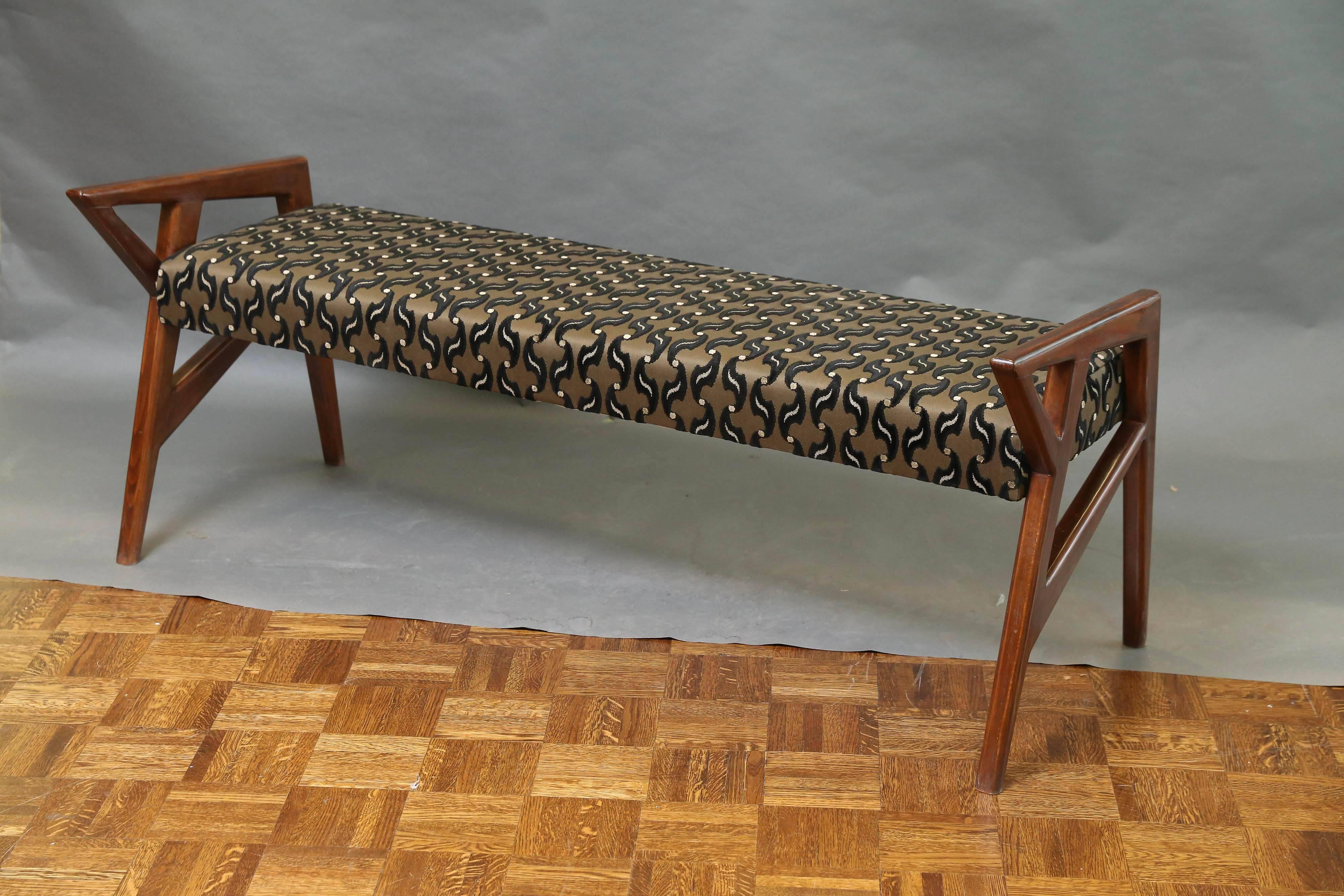 The bench is made out of walnut wood. Newly re-upholstered in a geometric pattern fabric. Bench has armrests on each of the sides that are connected with supporting legs. 
 Condition is perfect. Restored and re-upholstered,

 Hungary, circa