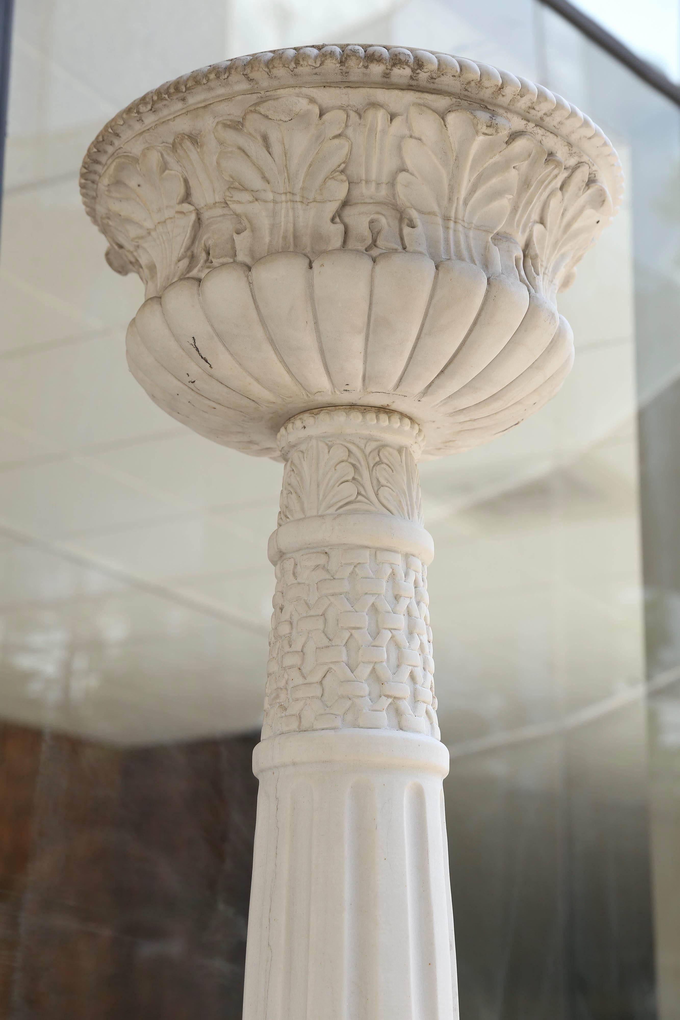 Tall and beautiful carved white marble torchiers. Carved rams heads
Decorate the corners of the bases. Scrolling embellishments are
Carved into all sides of this pair. Fluted columns support the top
Lantern that is also fluted and carved foliate