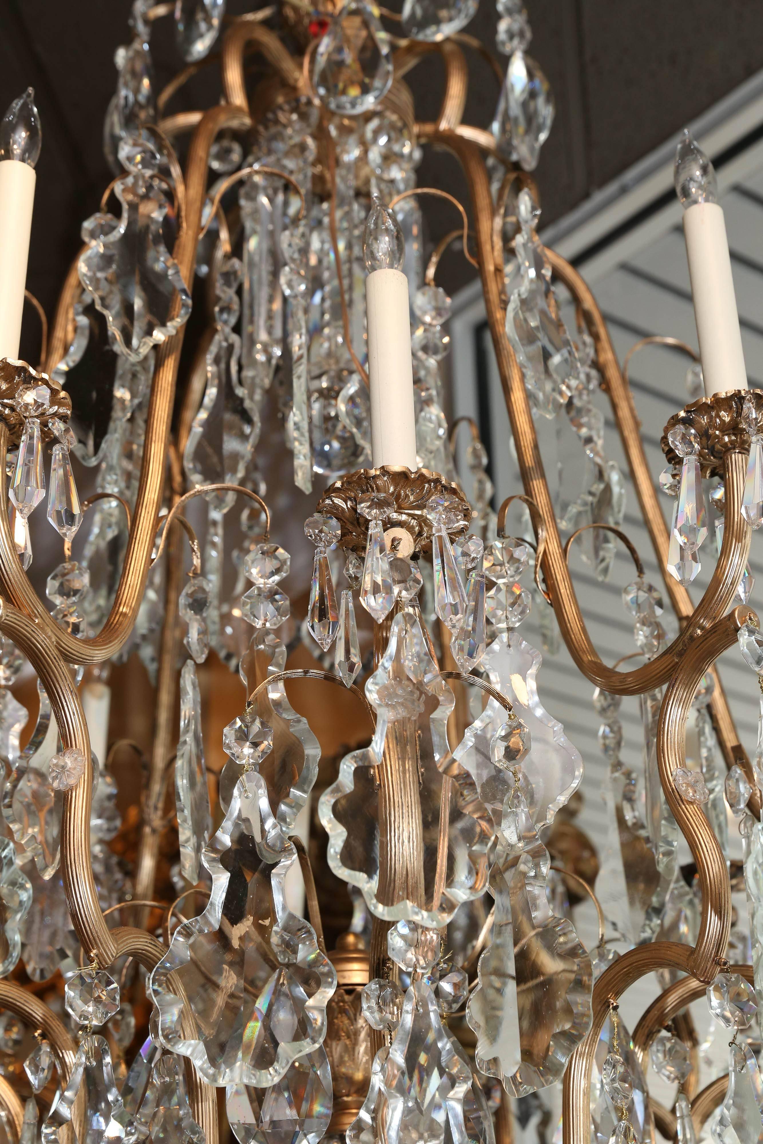 Impressive chandelier with scrolling arms supporting large cut crystal
pendants.

 