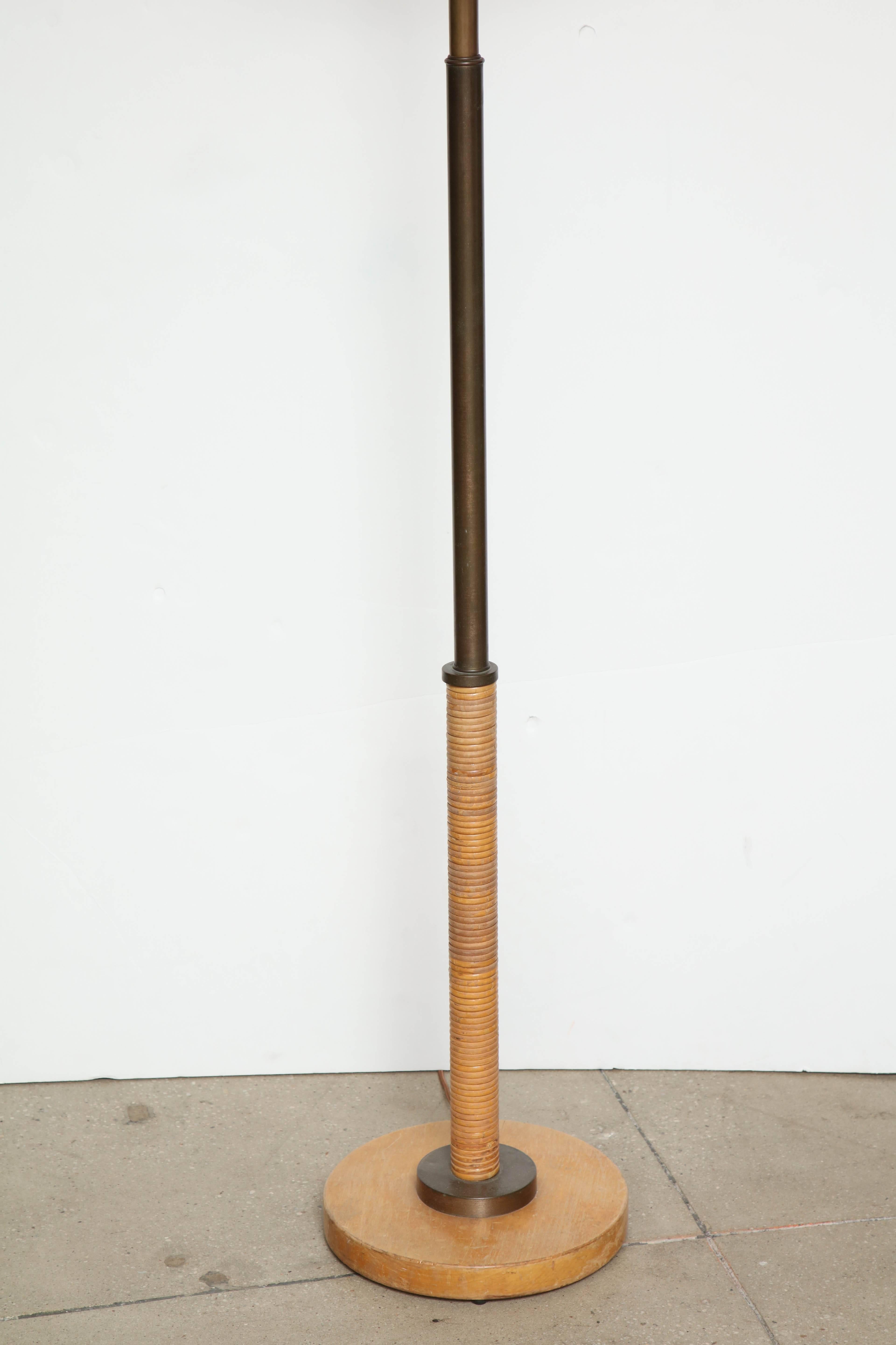 Russel Wright floor lamp with rattan wrapped body and bronze-plated brass hardware, circa 1950.