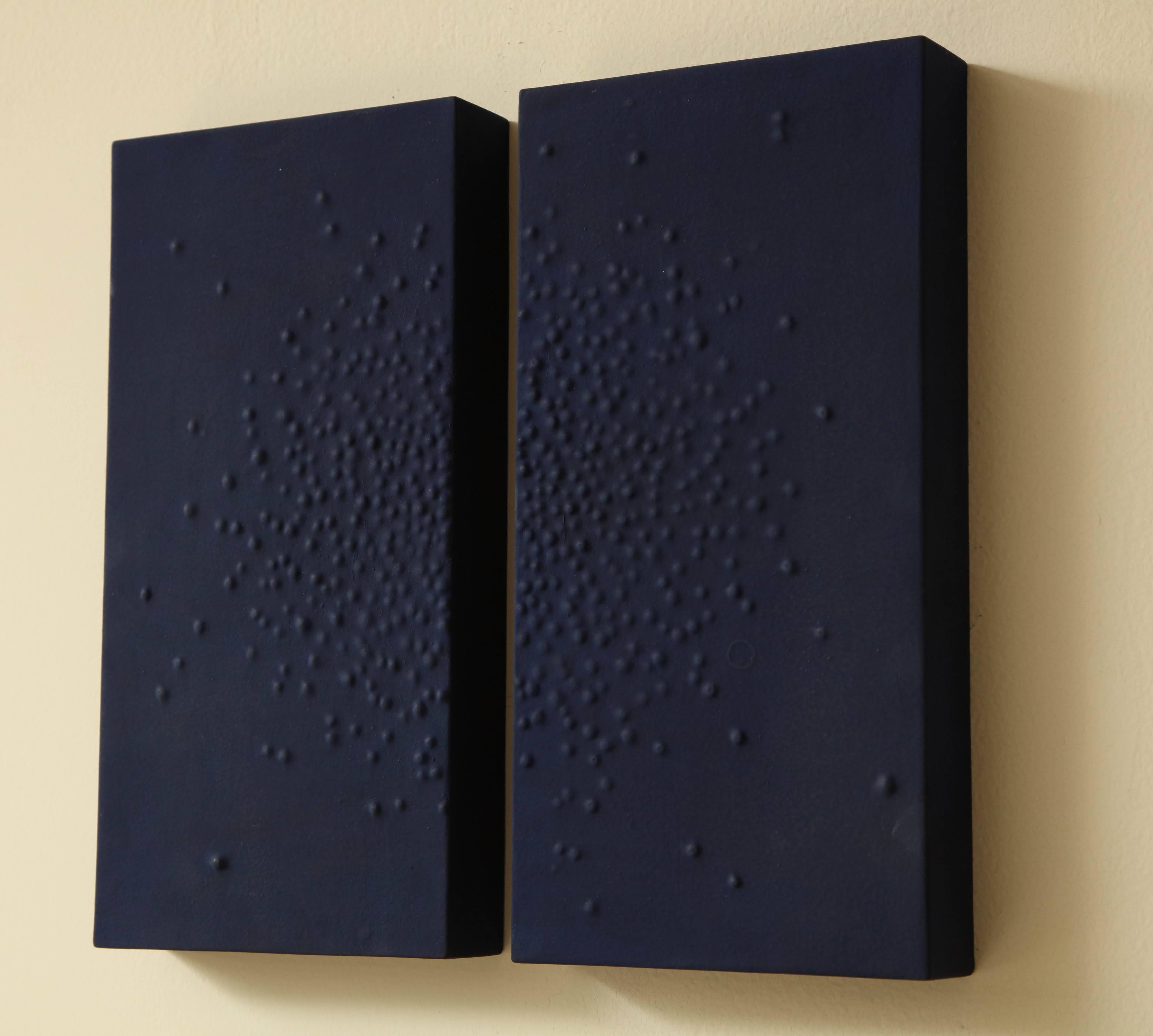 Navy blue diptych with raised gesso starburst motif by Carol Leskanic.

Piece measures at 12.5