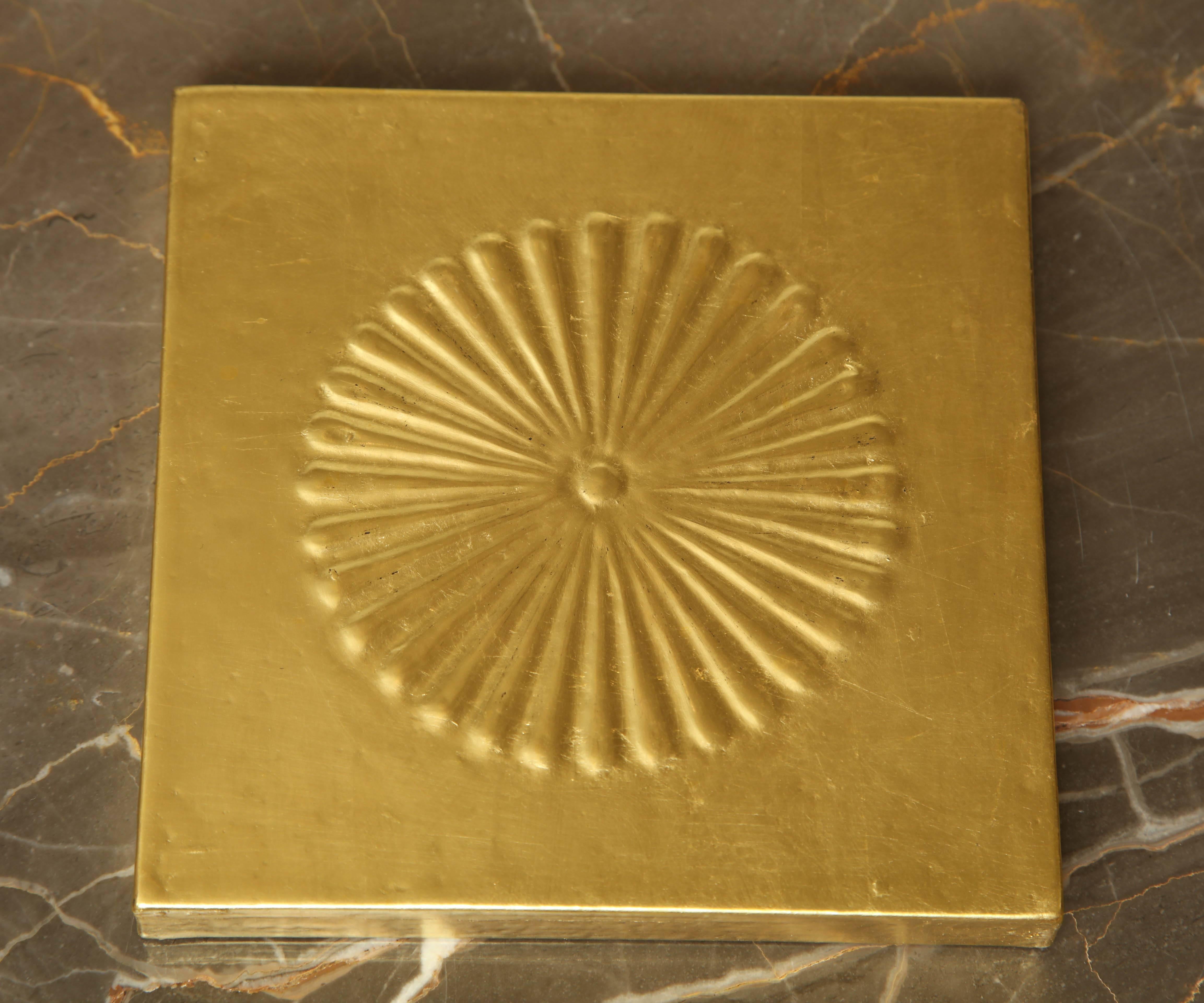 23-karat gold gilded panel with raised gesso Chrysanthemum motif. 

Piece measures at 6