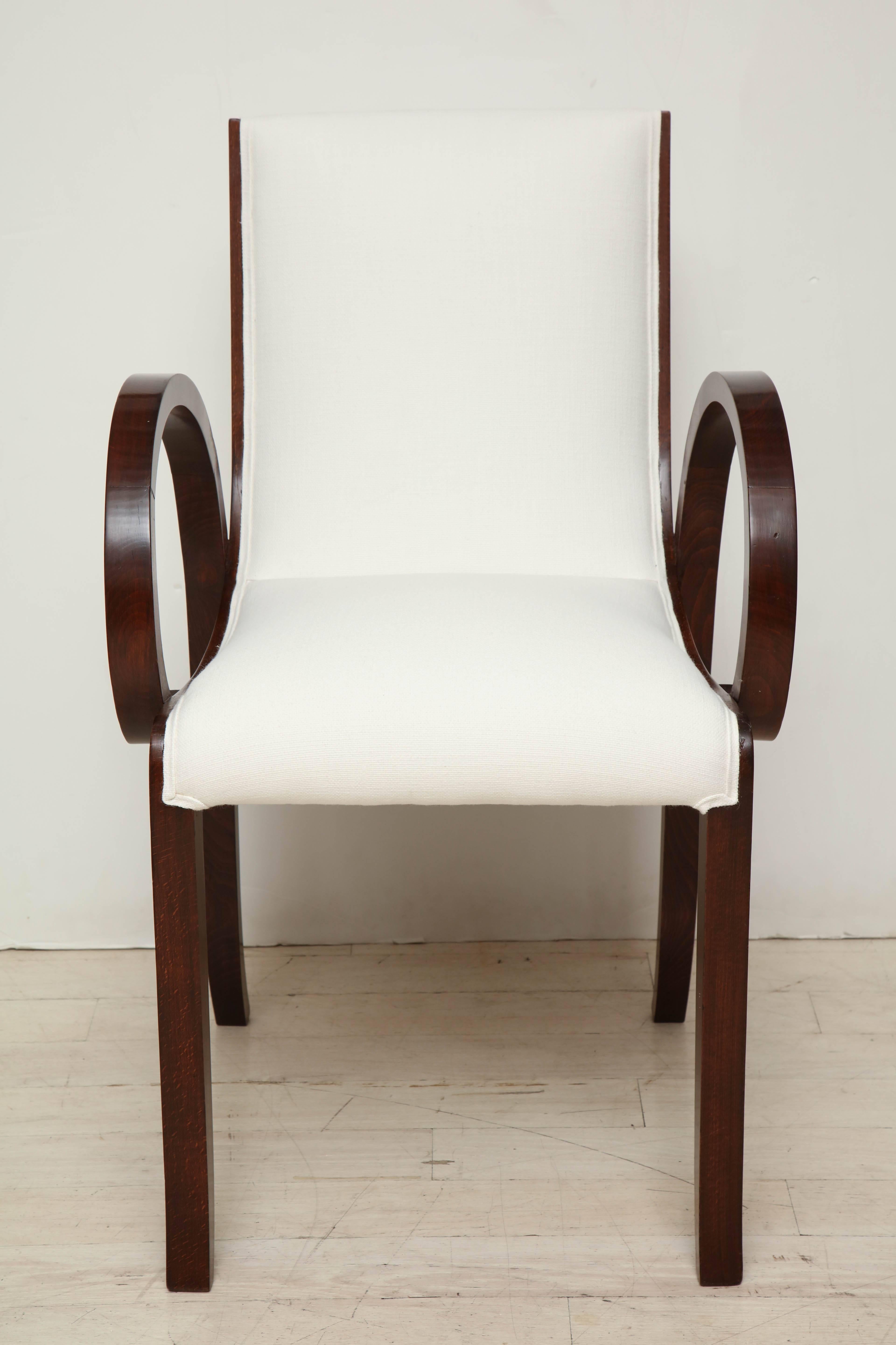 Beautiful French Art Deco beechwood armchair with curved seat and arms. Newly upholstered in white linen.