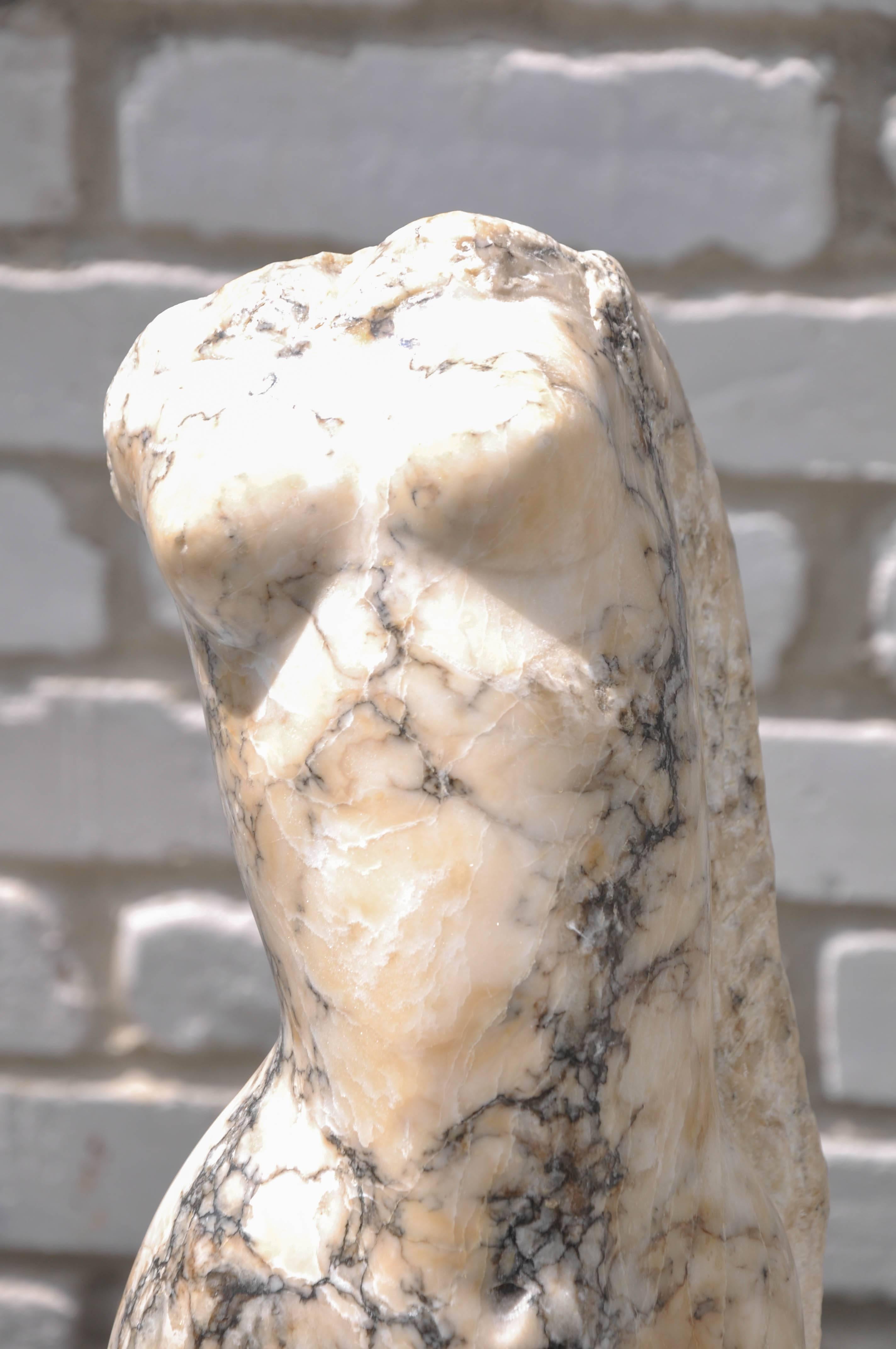 This one-of-a-kind graceful abstract headless, armless female torso Italian sculpture, hand-carved from an extraordinary cream marble with heavy gray veining, sculpted body seems to be swaying as if dancing, supported on a shapely nonconforming