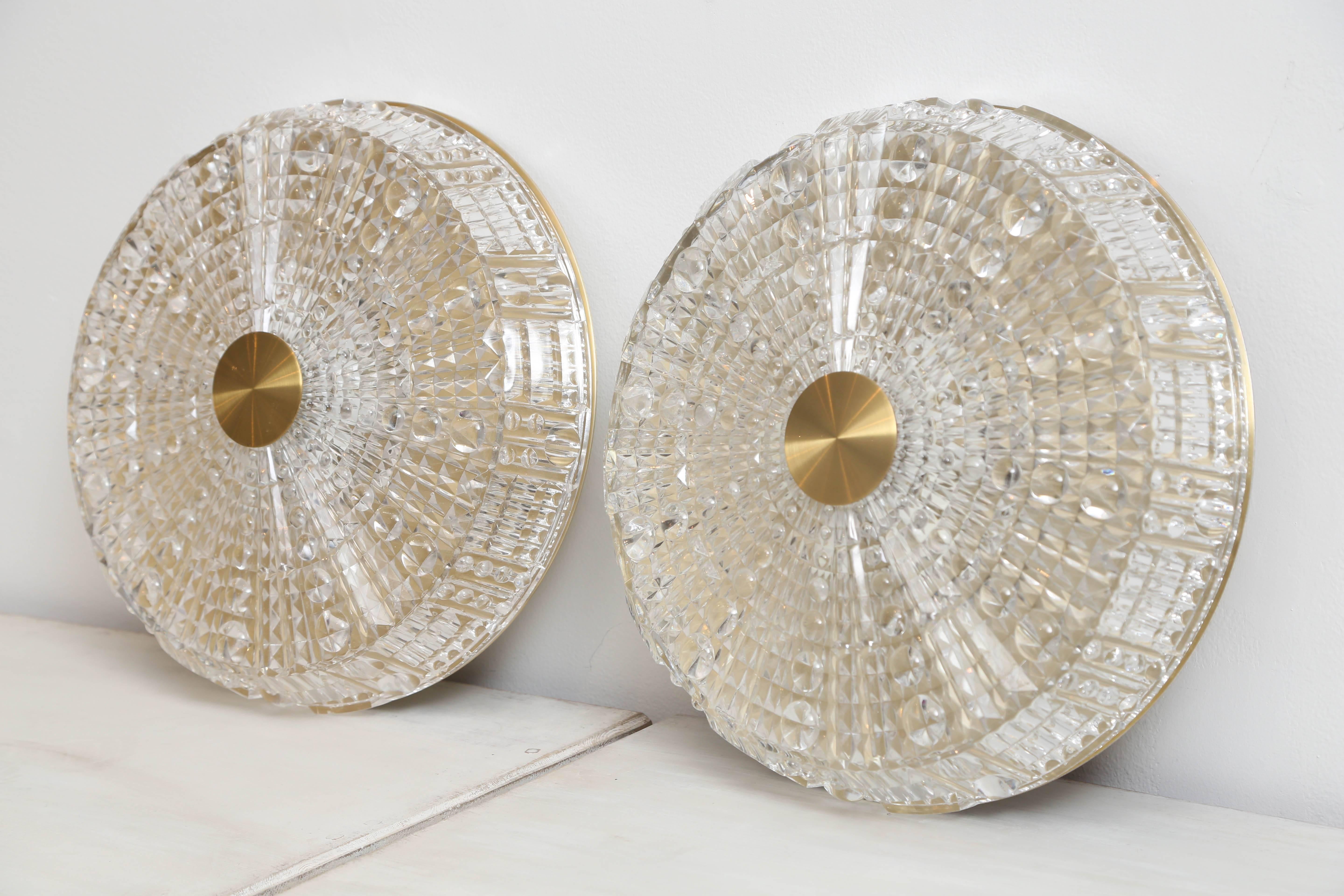 Pair of Orrefors crystal and brass flush mount light fixtures by Carl Fagerlund.
Swedish, 1960s The crystal cover has raised circular pattern and raised diamond design.
Brass and crystal with six sockets each, takes six candelabra base