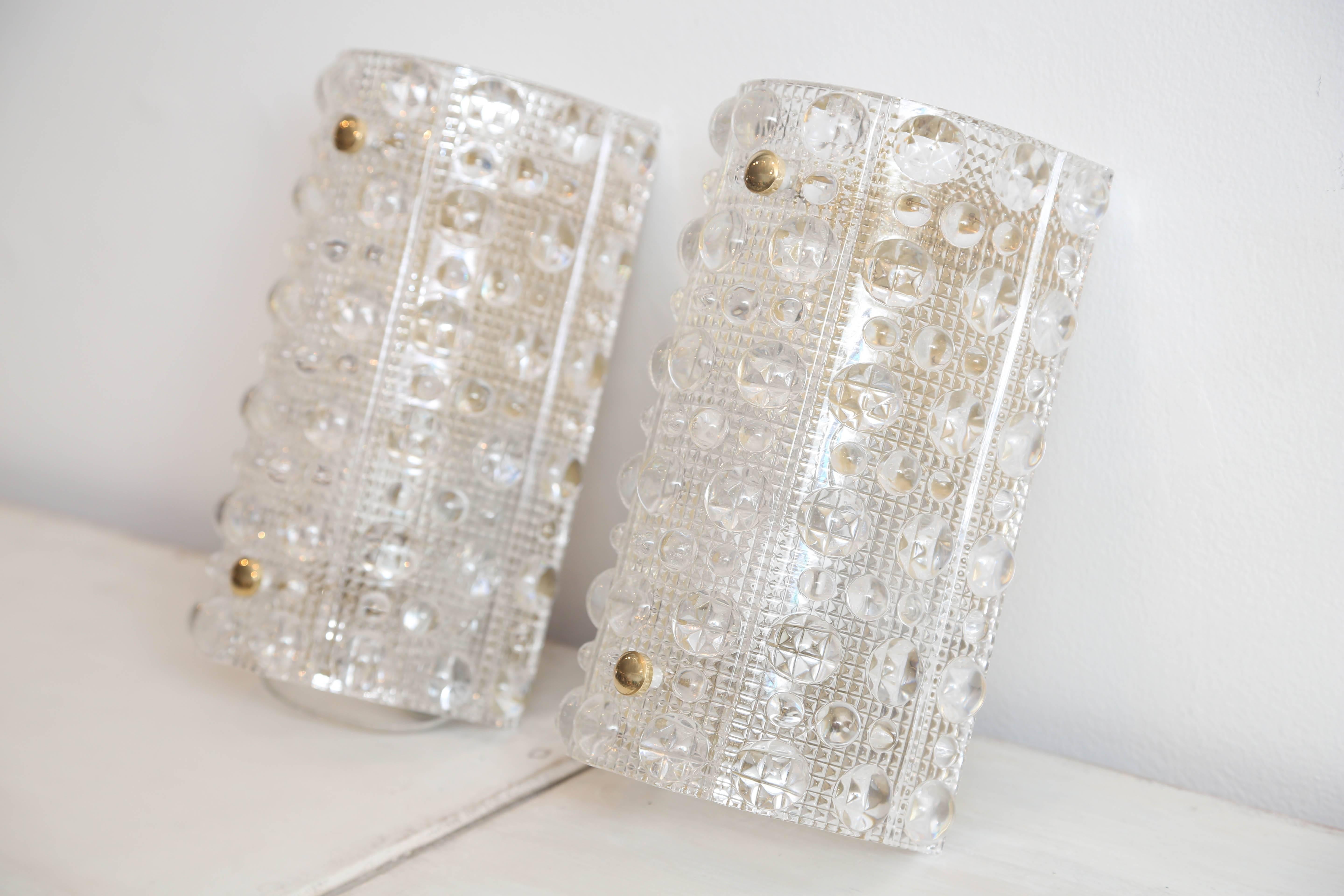 Brass and crystal Orrefors wall sconces designed by Carl Fagerlund.
Modern raised bubble pattern.
One socket each. 40 watt max candelabra base bulb
Sconces have been cleaned,polished and rewired to US standards.
circa 1960s

Measures: H 10