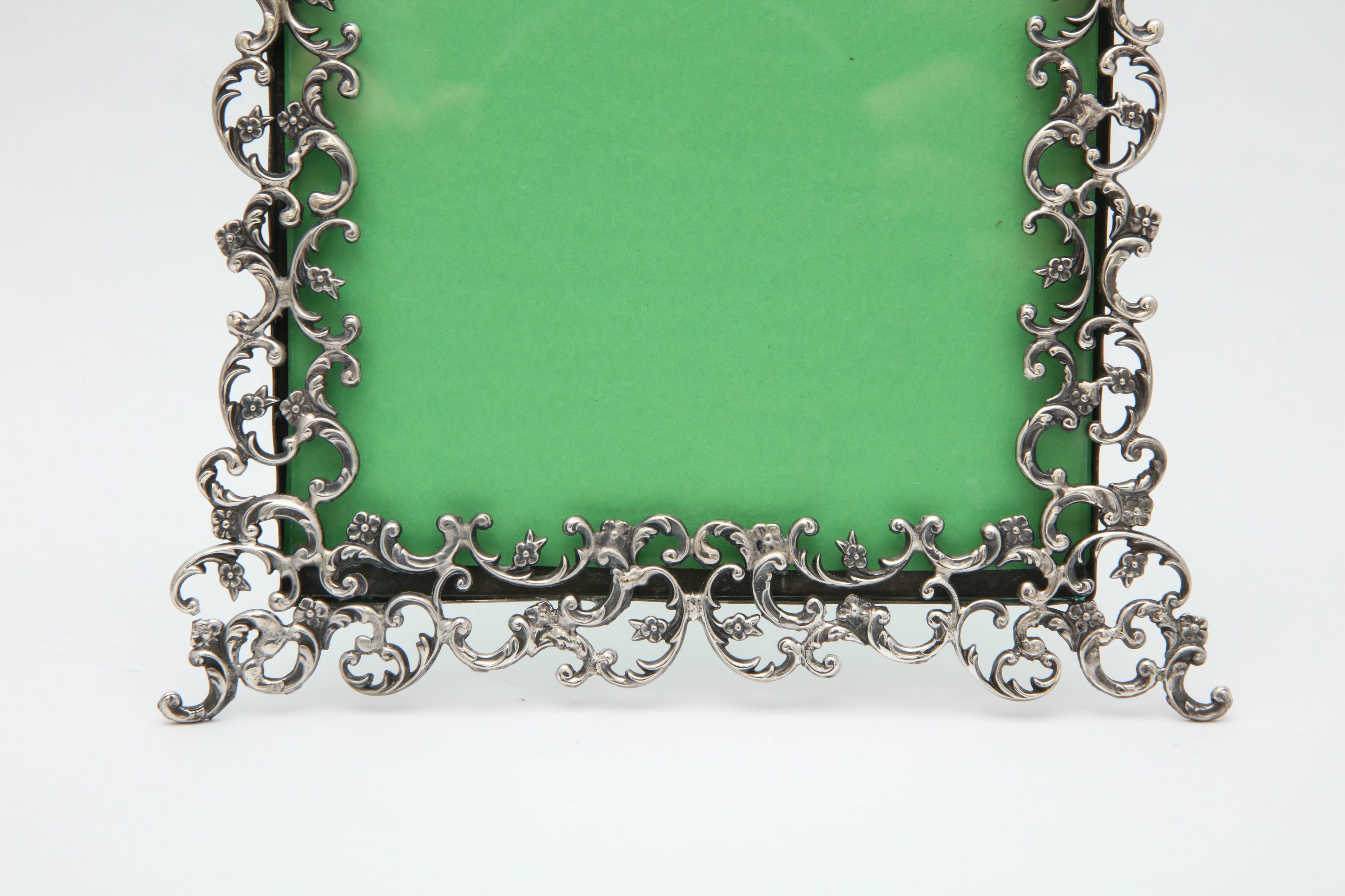 Victorian, sterling silver picture frame, American, circa 1895. Easel of frame is also sterling silver. Measures: 5 3/4 inches wide x 8 inches high (at highest point) x 5 1/4 inches deep when sterling easel is in open position. Will show a photo 4