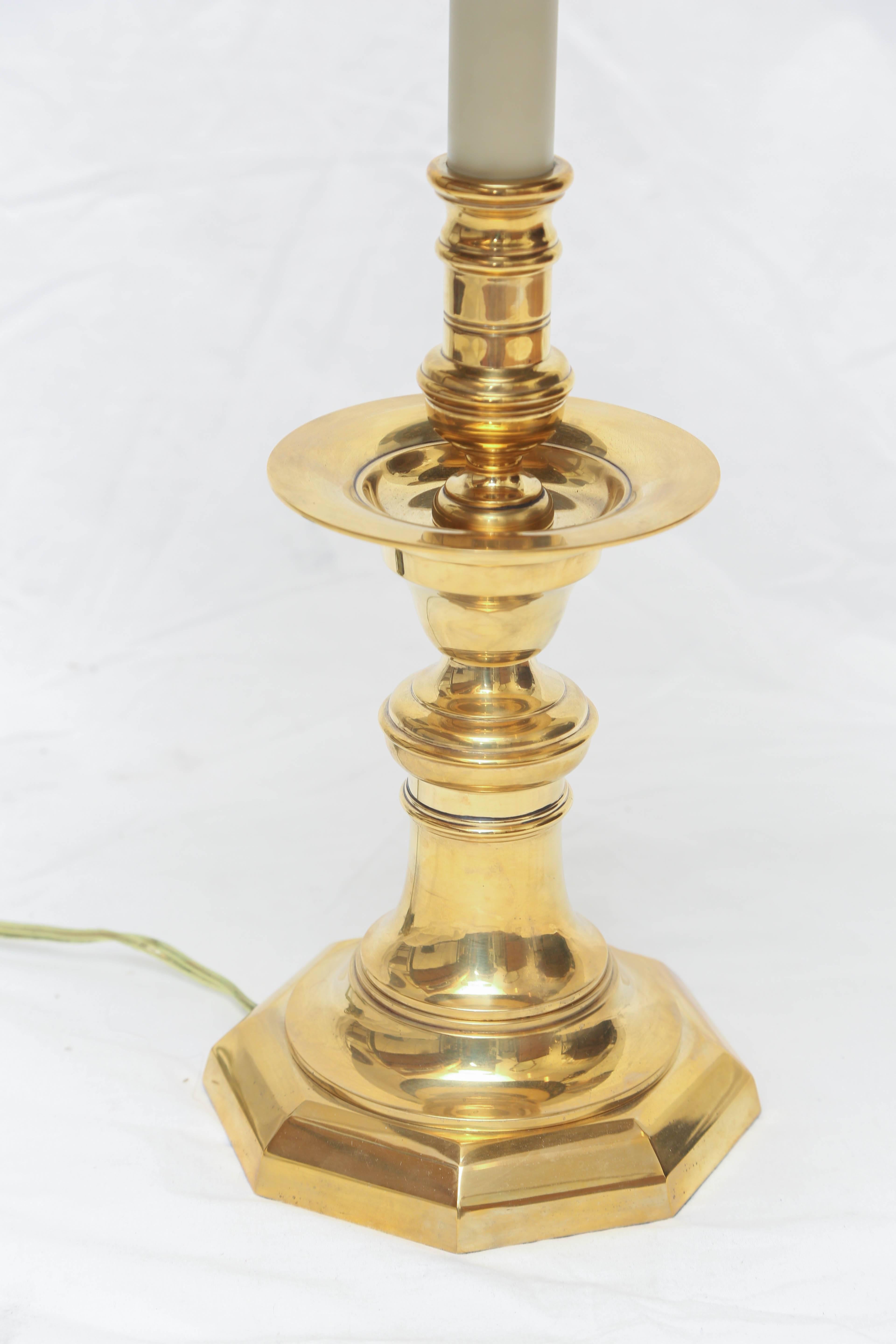 Classical solid brass candlestick lamp with black shade by Chapman.