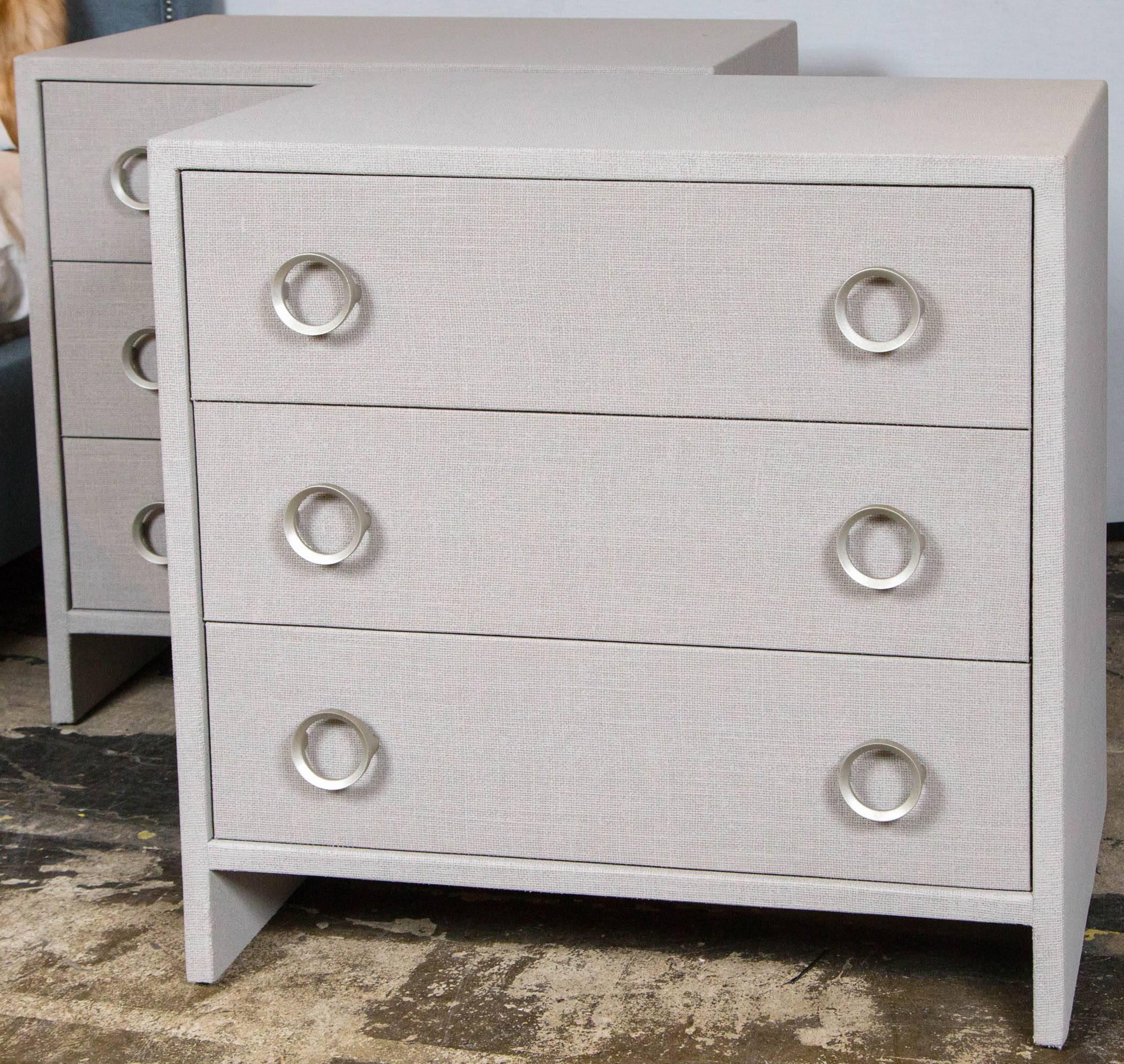 Three-drawer dresser wrapped in linen painted grey with silver leaf hardware.