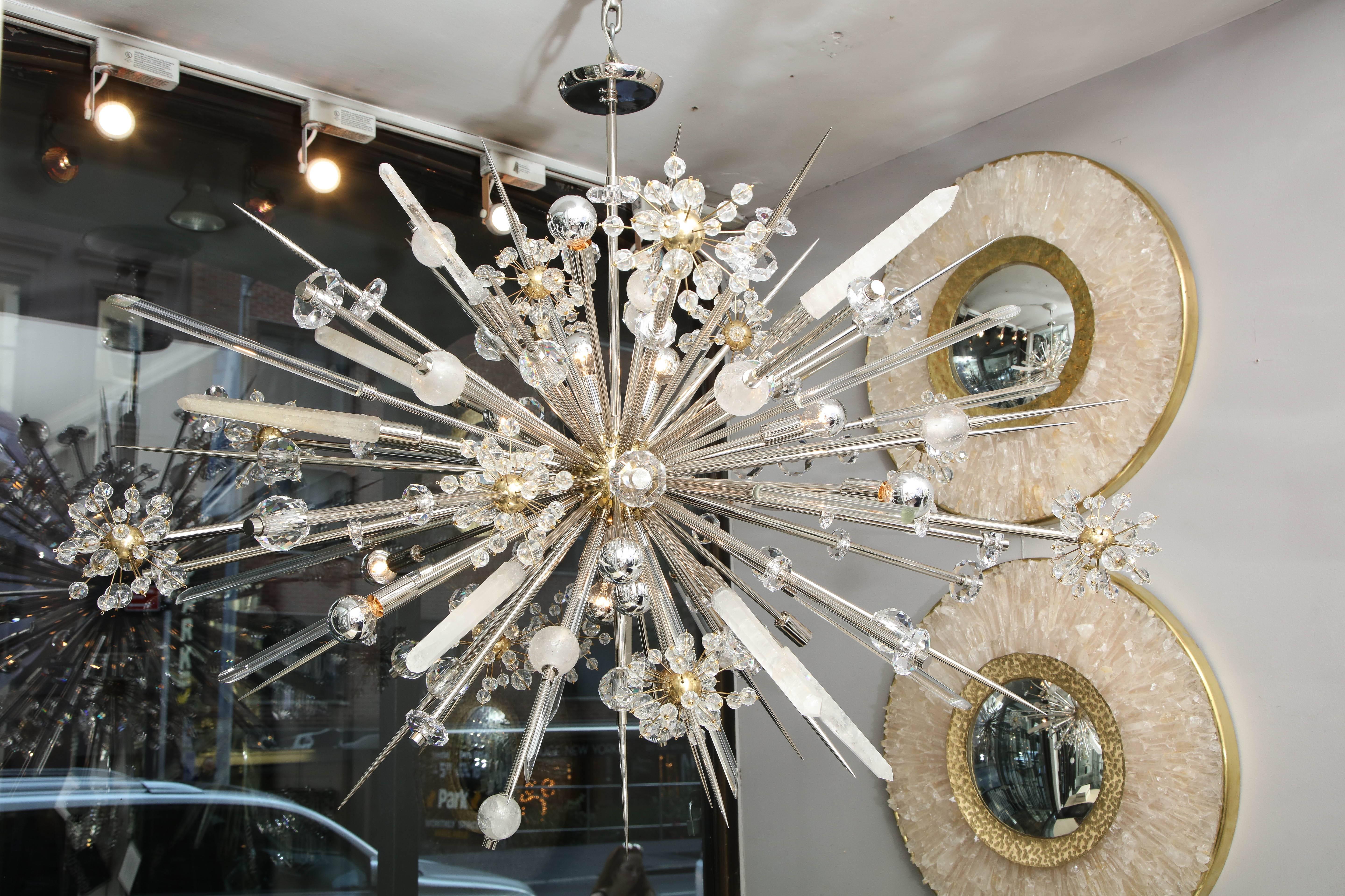 Elegant and iconic chandelier that is flexible in customization to your preference. The chandelier listed was made in polished nickel and polished brass finish on crystal cluster sphere and center sphere.