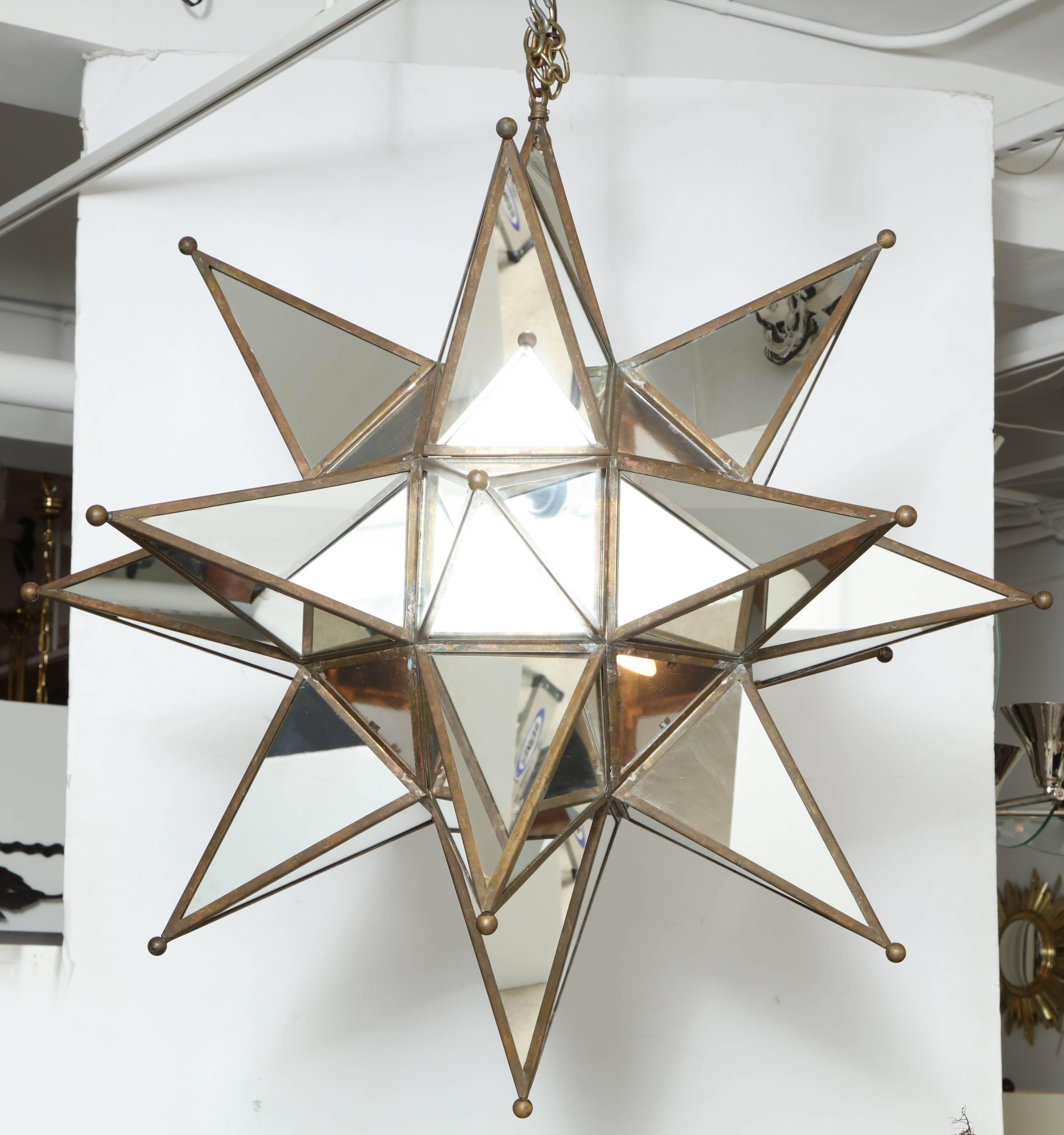 Grand mirror, glass and brass starburst light pendant light.