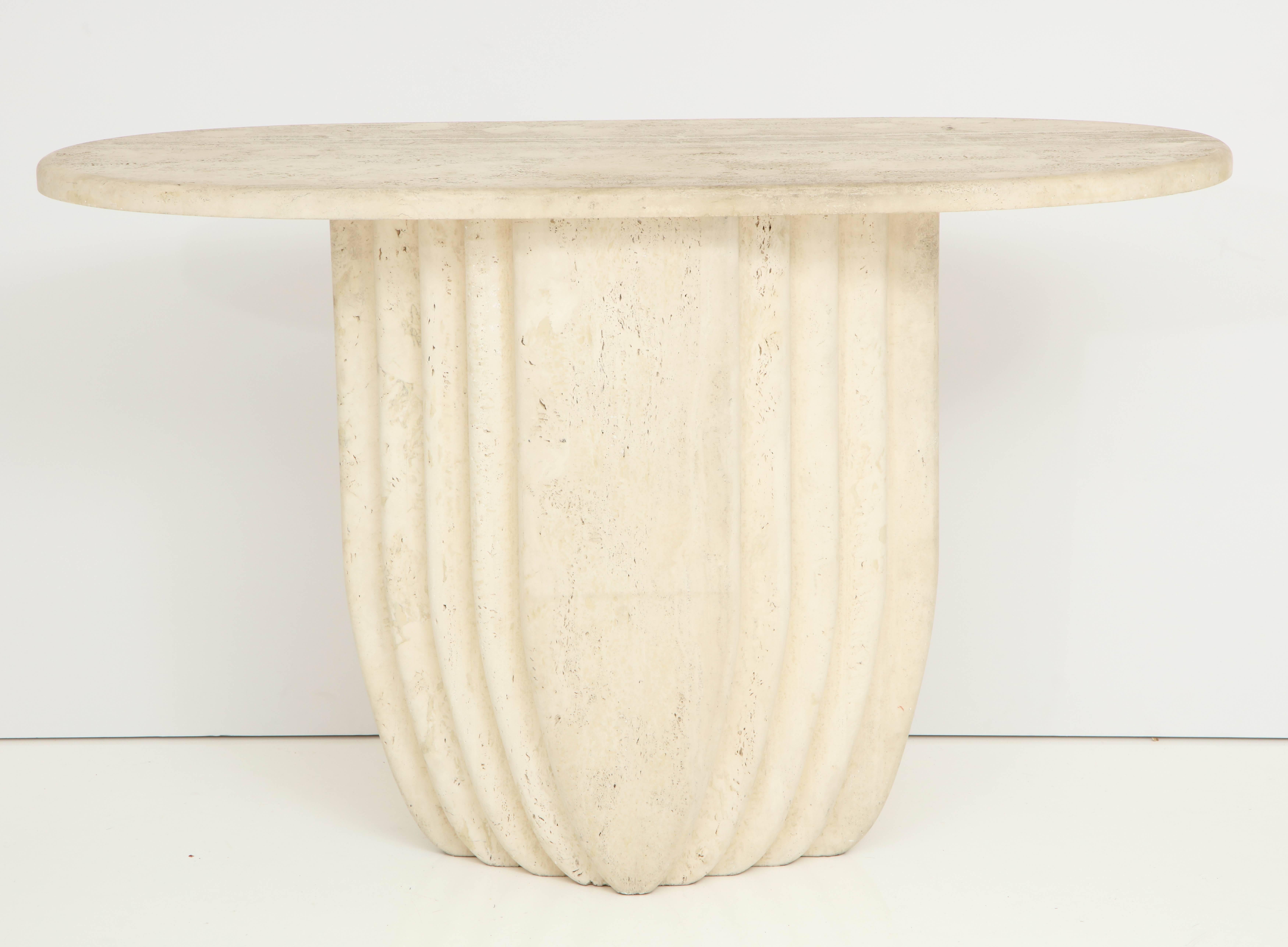 Beautiful natural oval travertine console table.
The base has a stepped form which is identical on the back, which supports a separate oval top.
 