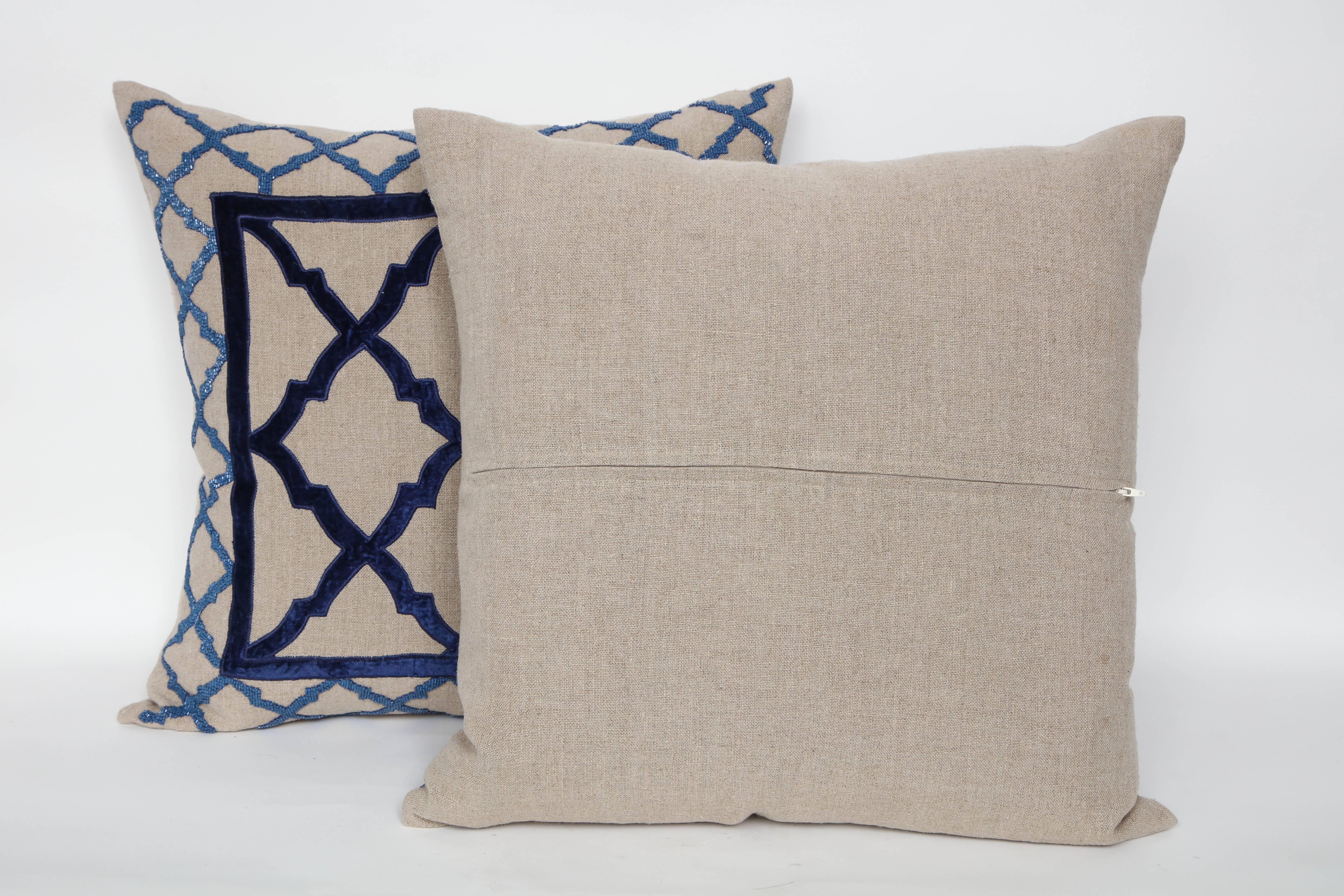Striking pair of heavy weight natural linen pillows trimmed with dark blue velvet trellis motif centres and light blue seed beaded borders, hidden zipper closure. Inserts are feather and down.