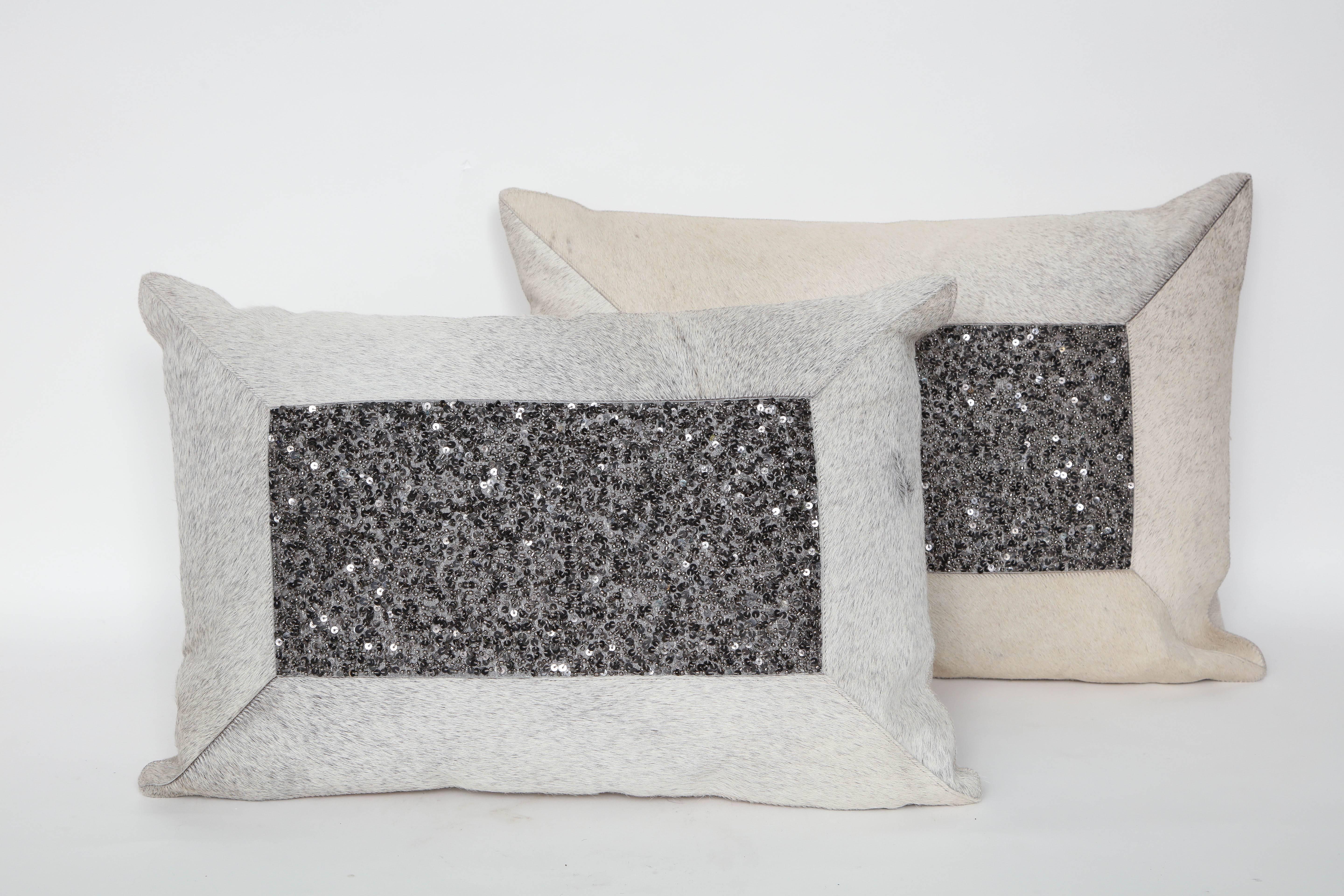 Pair of custom-made rectangular natural white, grey, beige hide pillows accented with grey bead centres and linen cotton backs. Feather down inserts, zipper closure. A sophisticated addition to any interior.