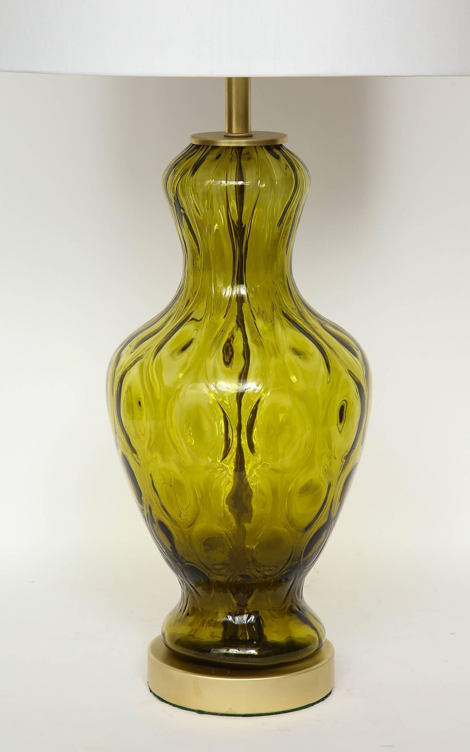 Pair of American Classic blown glass lamps with an all-over optic pattern on satin brass disc bases. Rewired for use in the USA.
