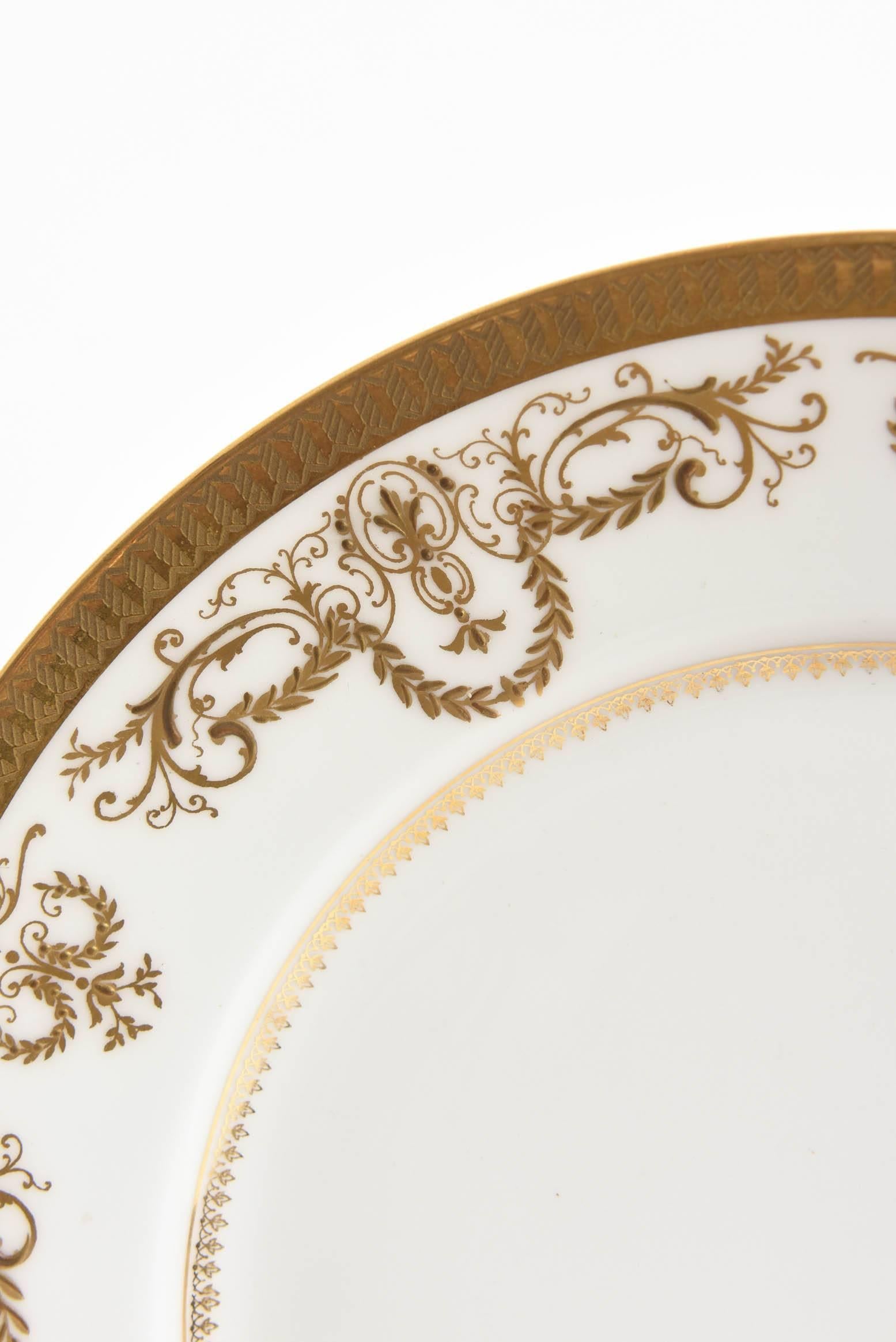 A pretty set of white and gold plates to go with all your fine porcelain tabletop. This set by Limoges has a nice raised tooled gilt foliate border on crisp white porcelain. Perfect size for salads, desserts, first course in very nice antique
