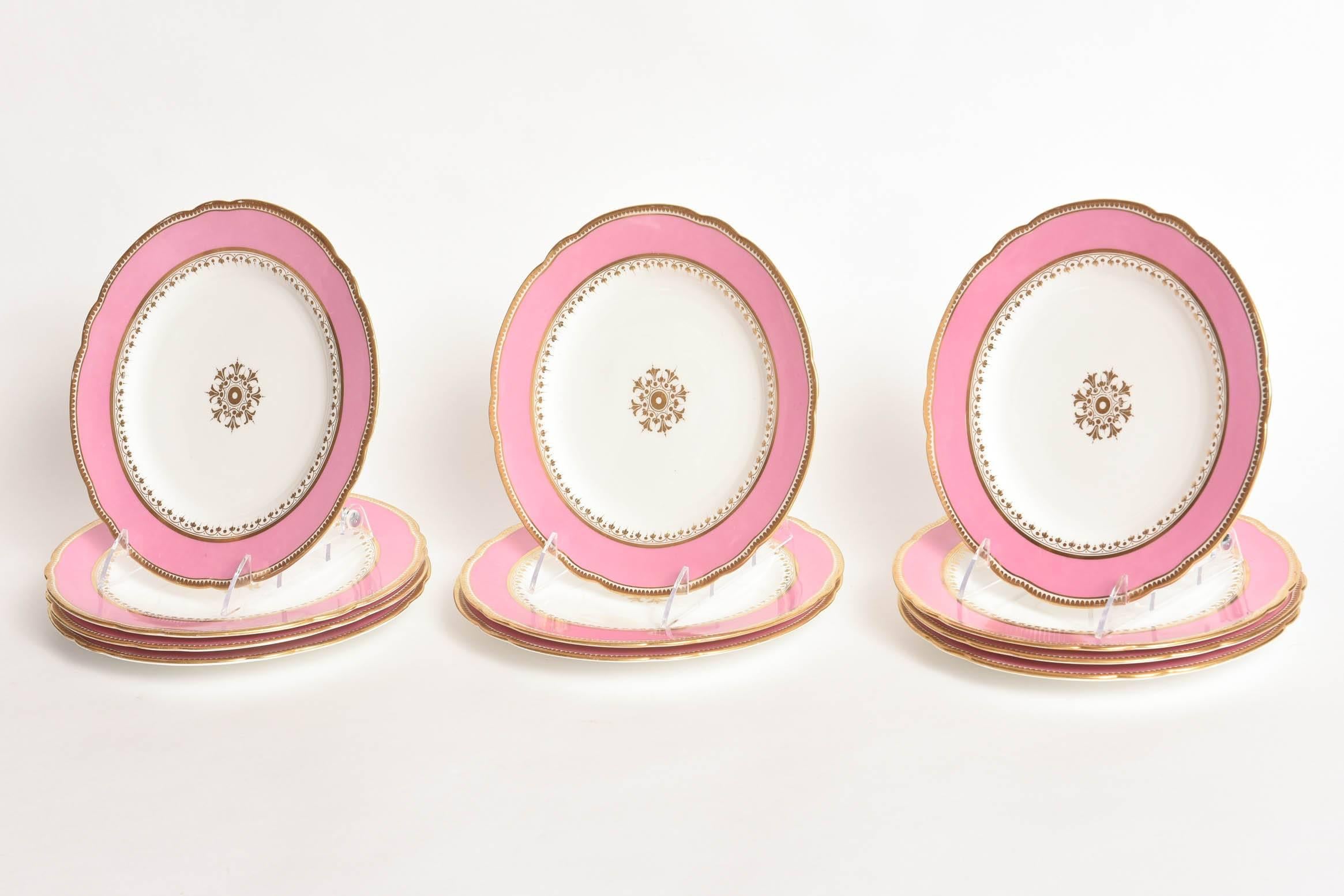 An elegant set of gilt trimmed plates featuring vibrant pink collars and a centre medallion. Perfect for first course, salad or dessert and retaining almost all of their center medallions where we usually see the age wear first. Crisp white