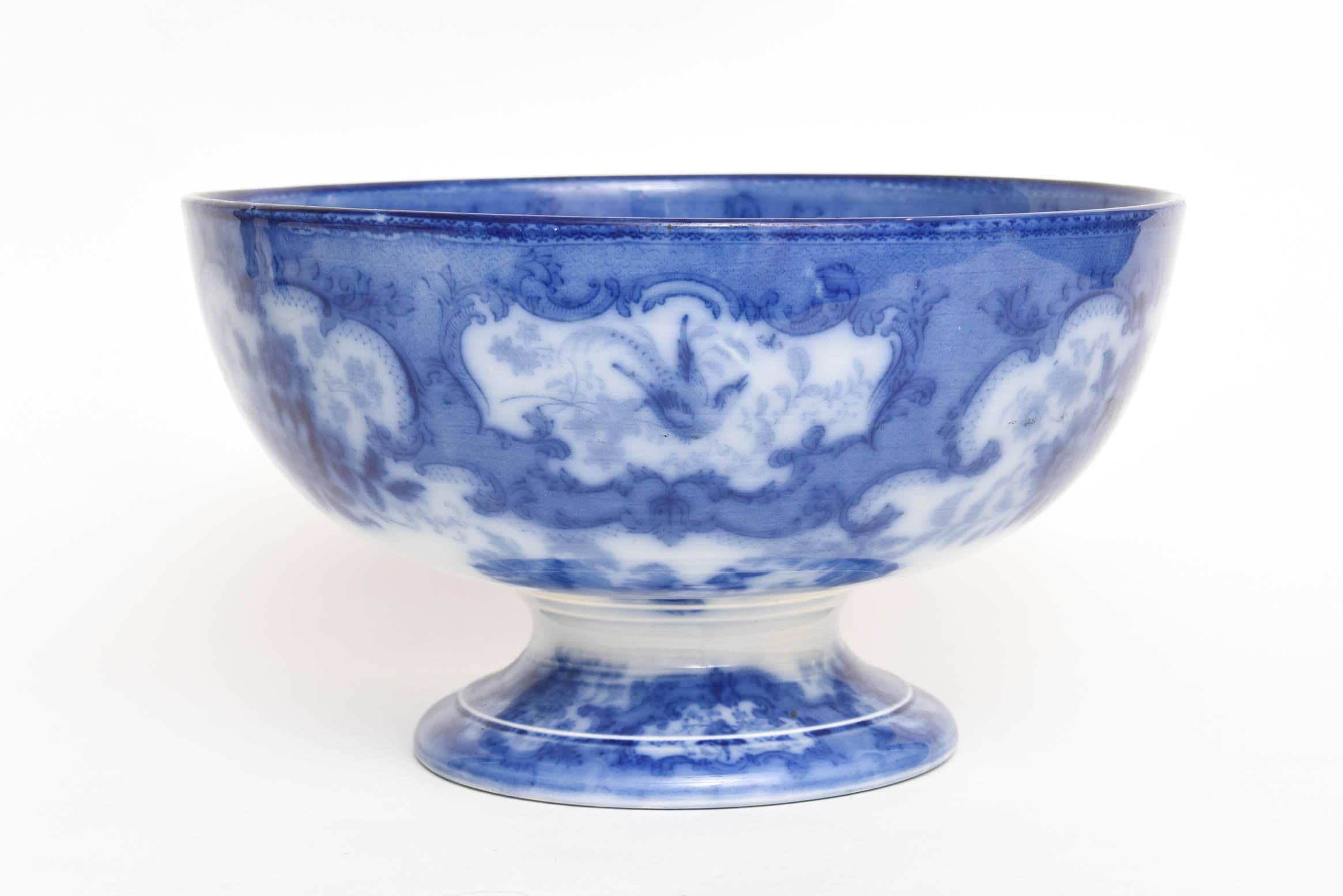 A charming pedestal porcelain punch bowl dating to the last quarter 19th century. This beautifully colored blue (flowing) bowl has nice proportions and is in very good antique condition with no chips, cracks or color fade. We love the center scenic