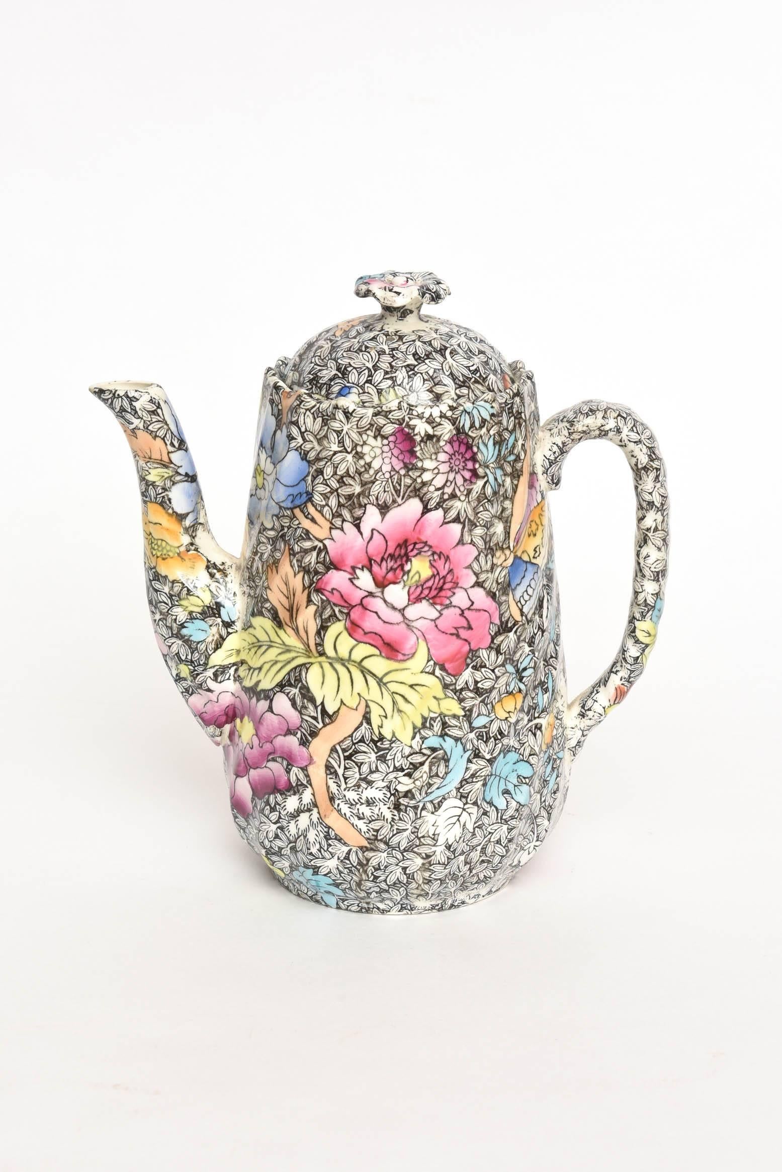 A delightful sweet coffee pot featuring an Aesthetic movement background with nicely hand colored and vividly painted florals. All pieces are in super condition and just the smallest amount of crazing which does not affect the beauty or complete