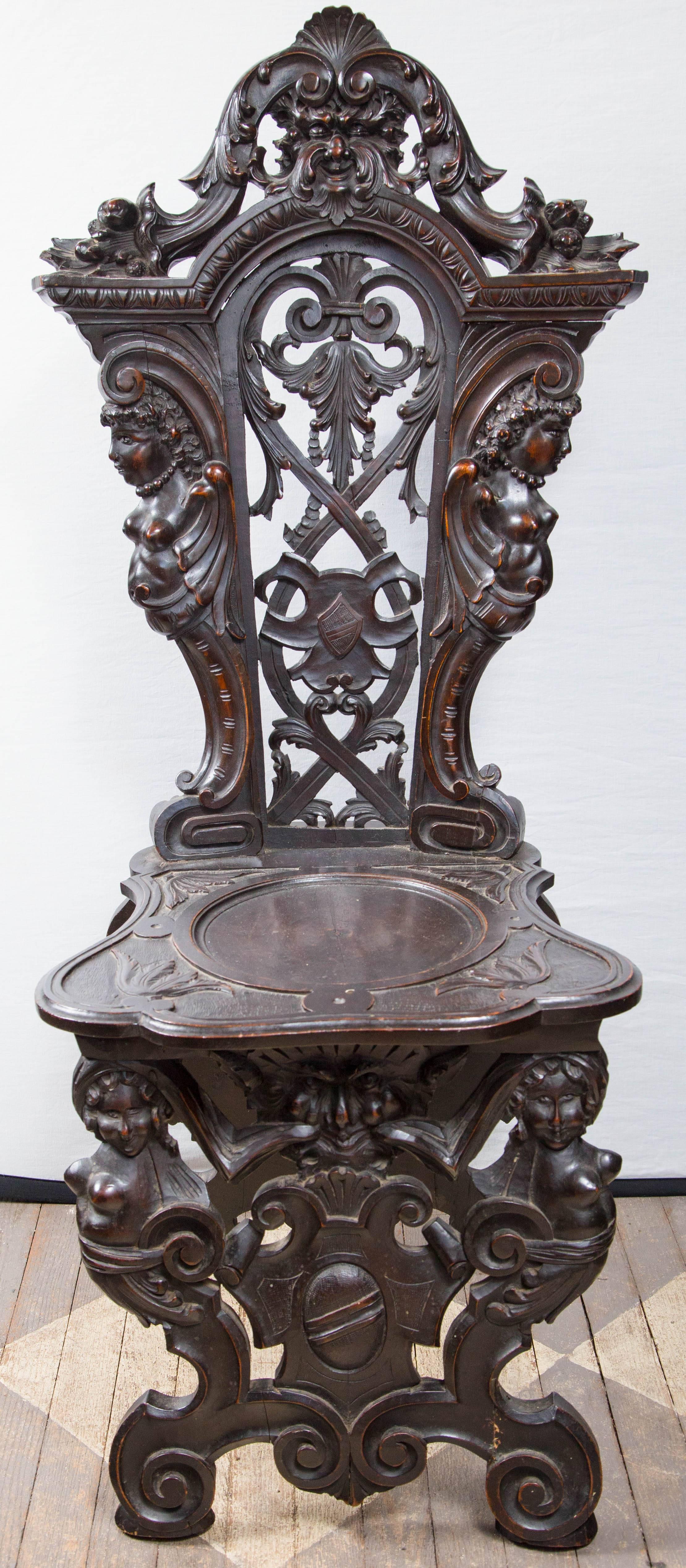 Extremely well and deeply carved rare pair of Italian Renaissance side chairs, called sgabelli, Small losses to the back and feet. Carved of solid walnut. Beautiful patina.