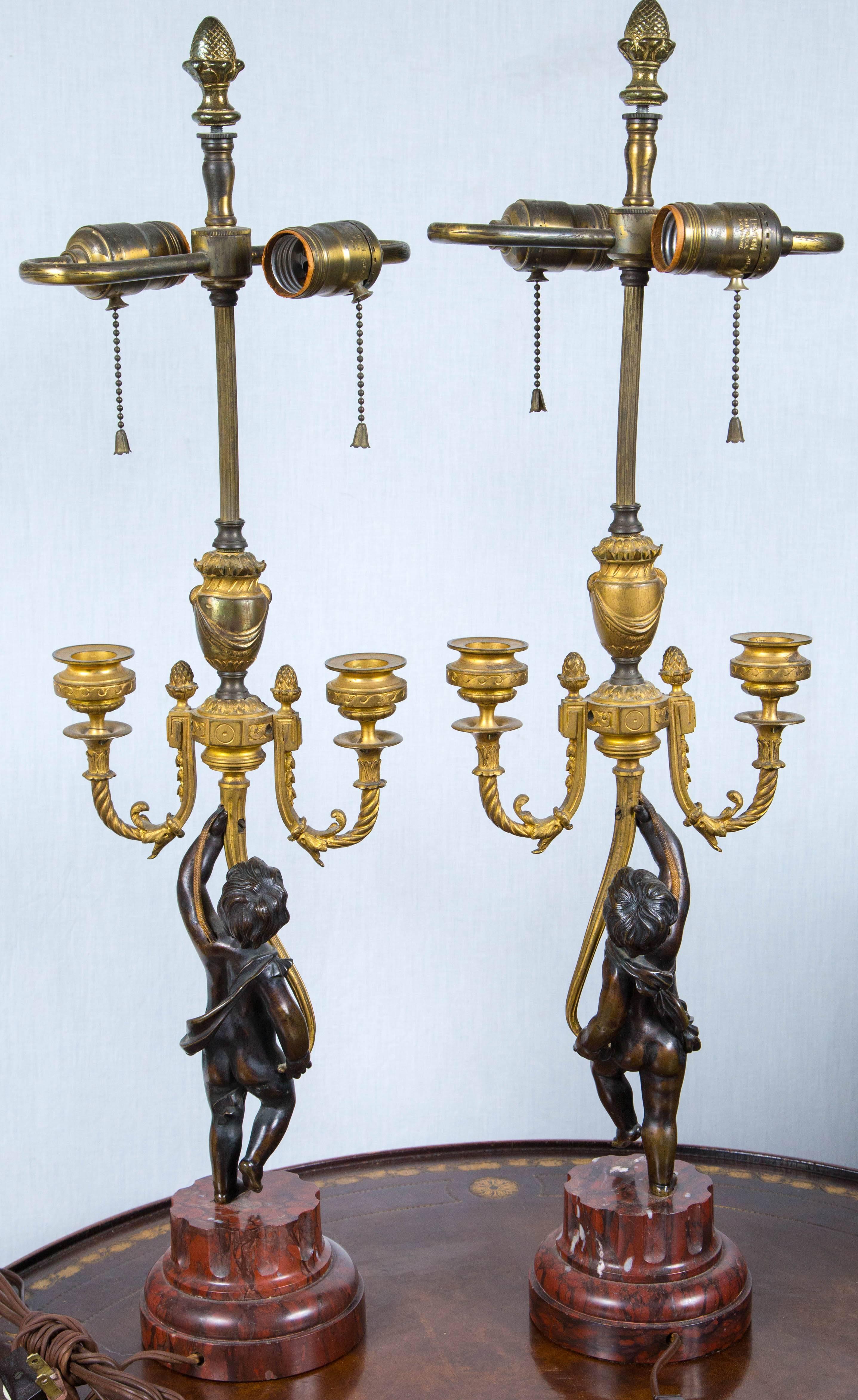 Carved Pair of Antique Gilt and Patinated Bronze Putti Candelabra For Sale