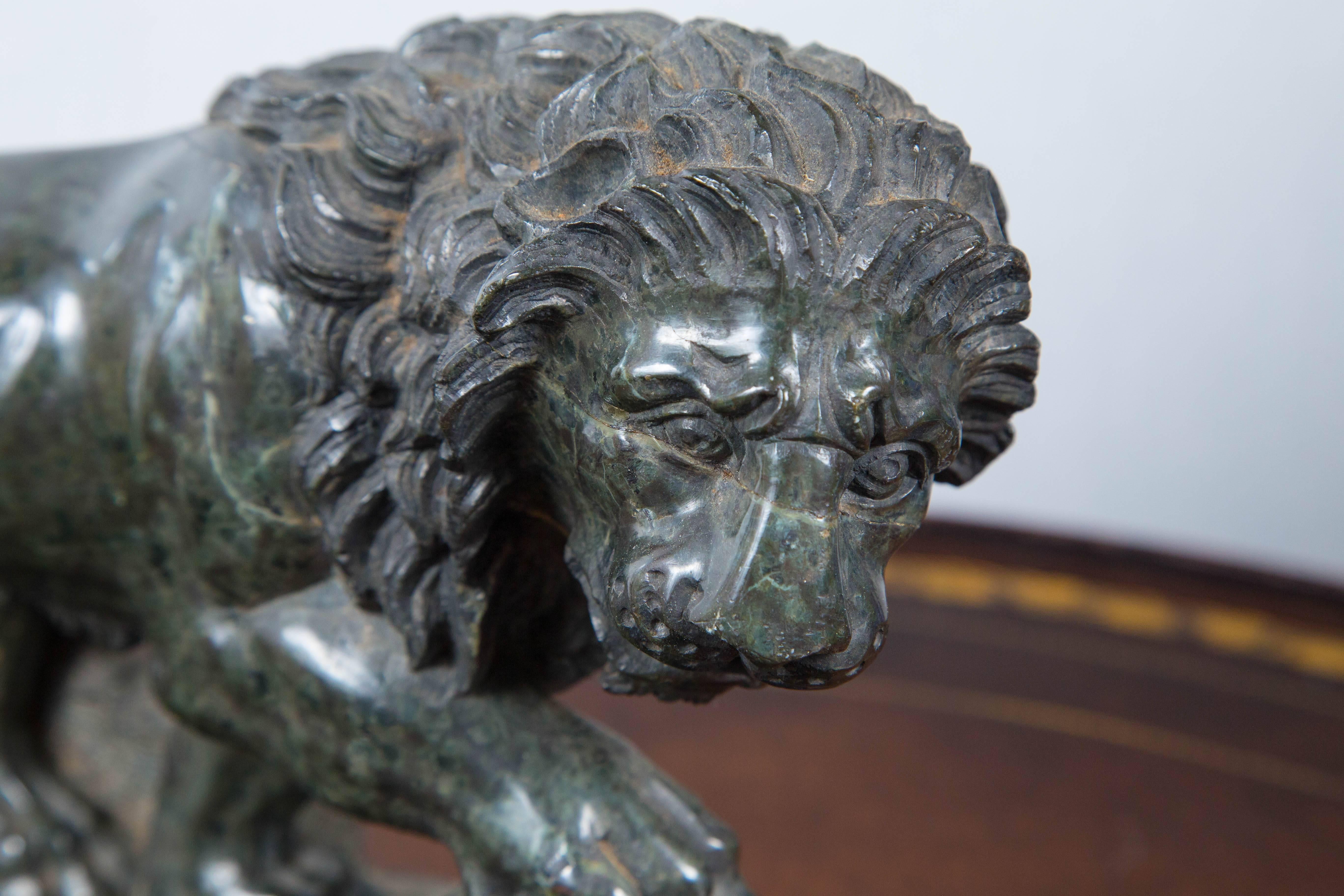 This lion, in dark green marble is a late 19th-early 20th century rendition of one the Medici lions. The Medici lions are a pair of marble sculptures of lions, one of which is of ancient origin, the other a 16th century pendant; both were by 1598