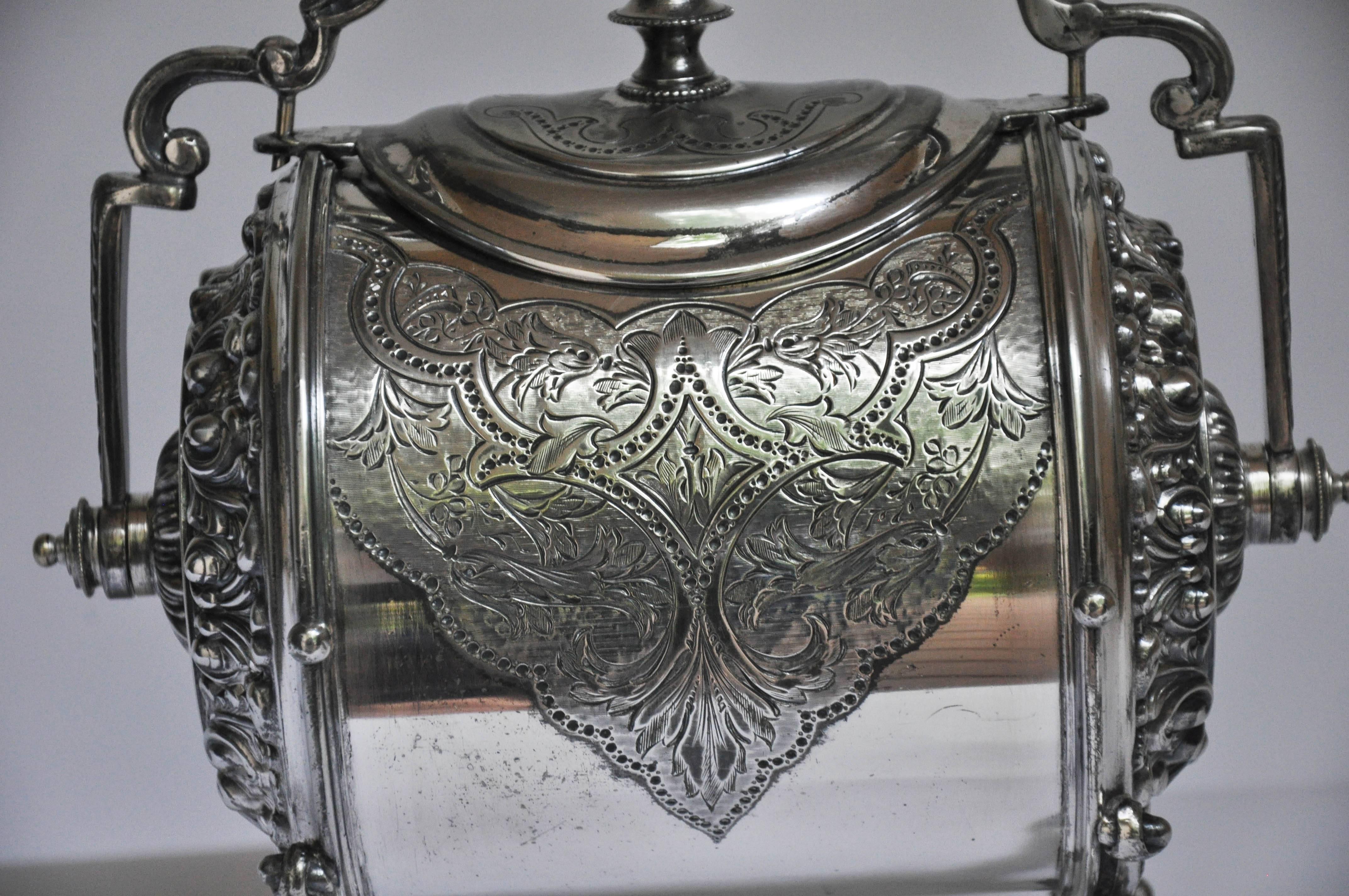Charming silver bun warmer, every aspect of this superbly engraved silver bun warmer illustrates why it always held a prominent place on the dining table. Each front side of the barrel is heavily engraved with a shield that encompasses an intricate