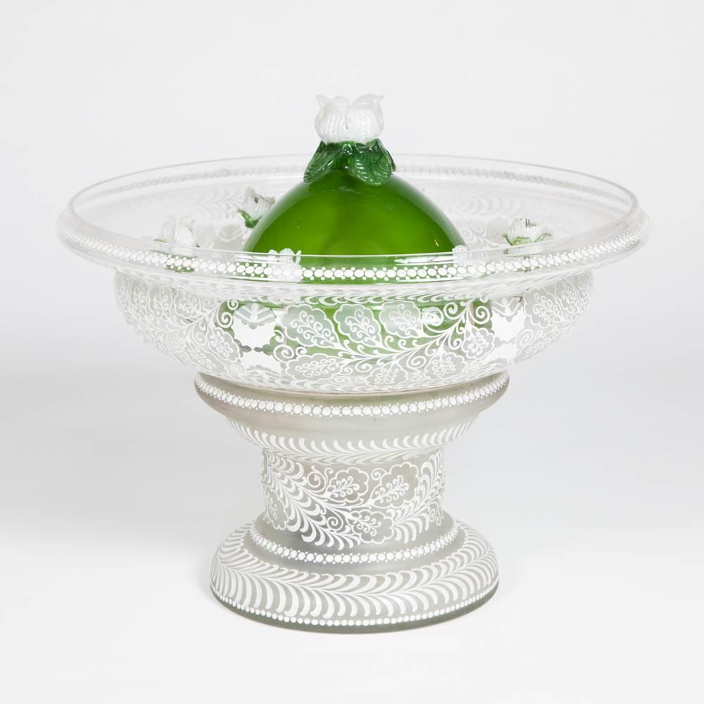 A midcentury glass table fountain, probably Venetian/Italian. 

The fountain has six jets enclosed in green and white glass flowers. 

Modern electric pump fitted.