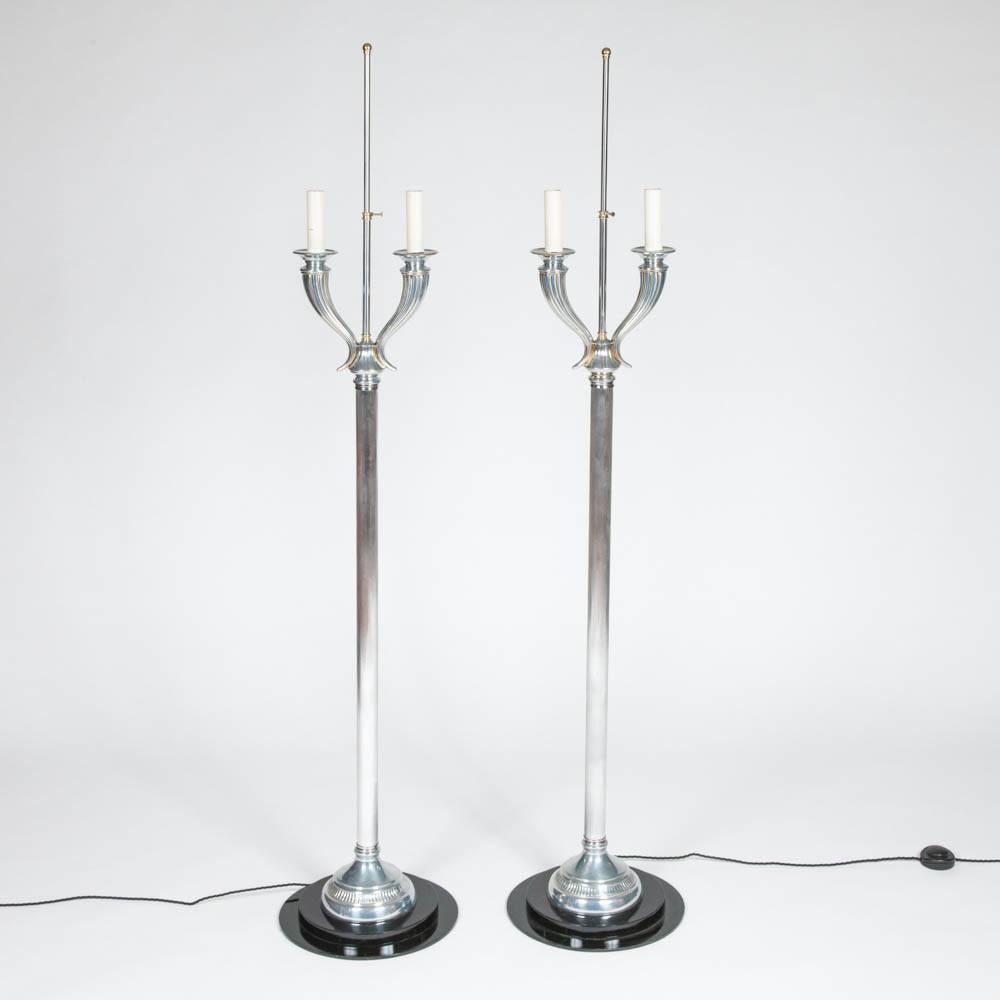 A pair of 1950s Art Deco style aluminium and brass standard lamps.

Mounted on ebonized bases.

Re-wired.