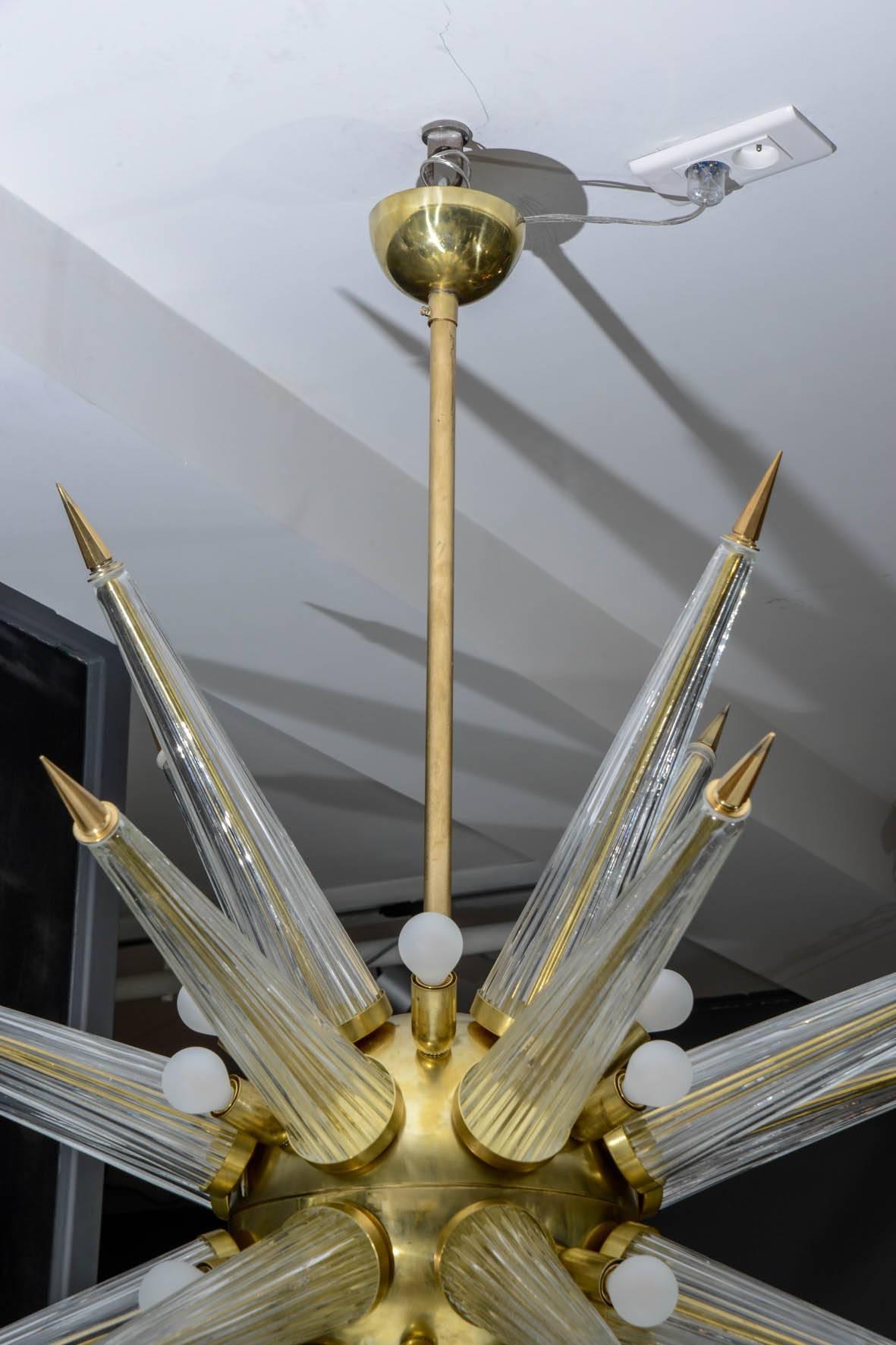 Big Sputnik style chandelier with a brass structure and Murano glass spikes with brass details at the points.