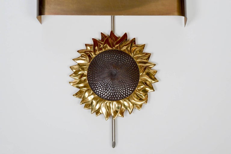 Beautiful wall sconces with a sun flower shape in two tones bronze by Maison Charles.