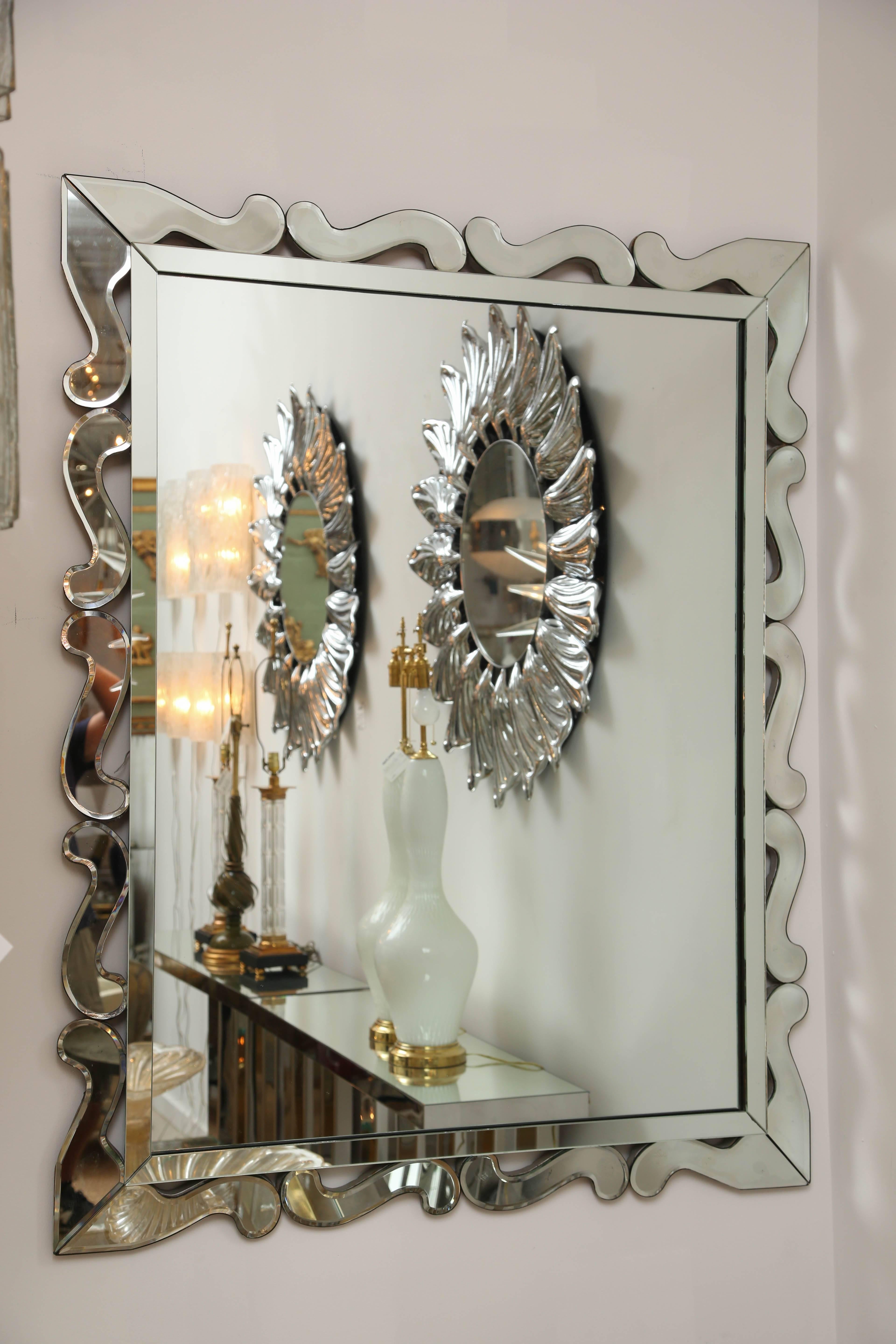 Art Deco mirror with scalloped edge.