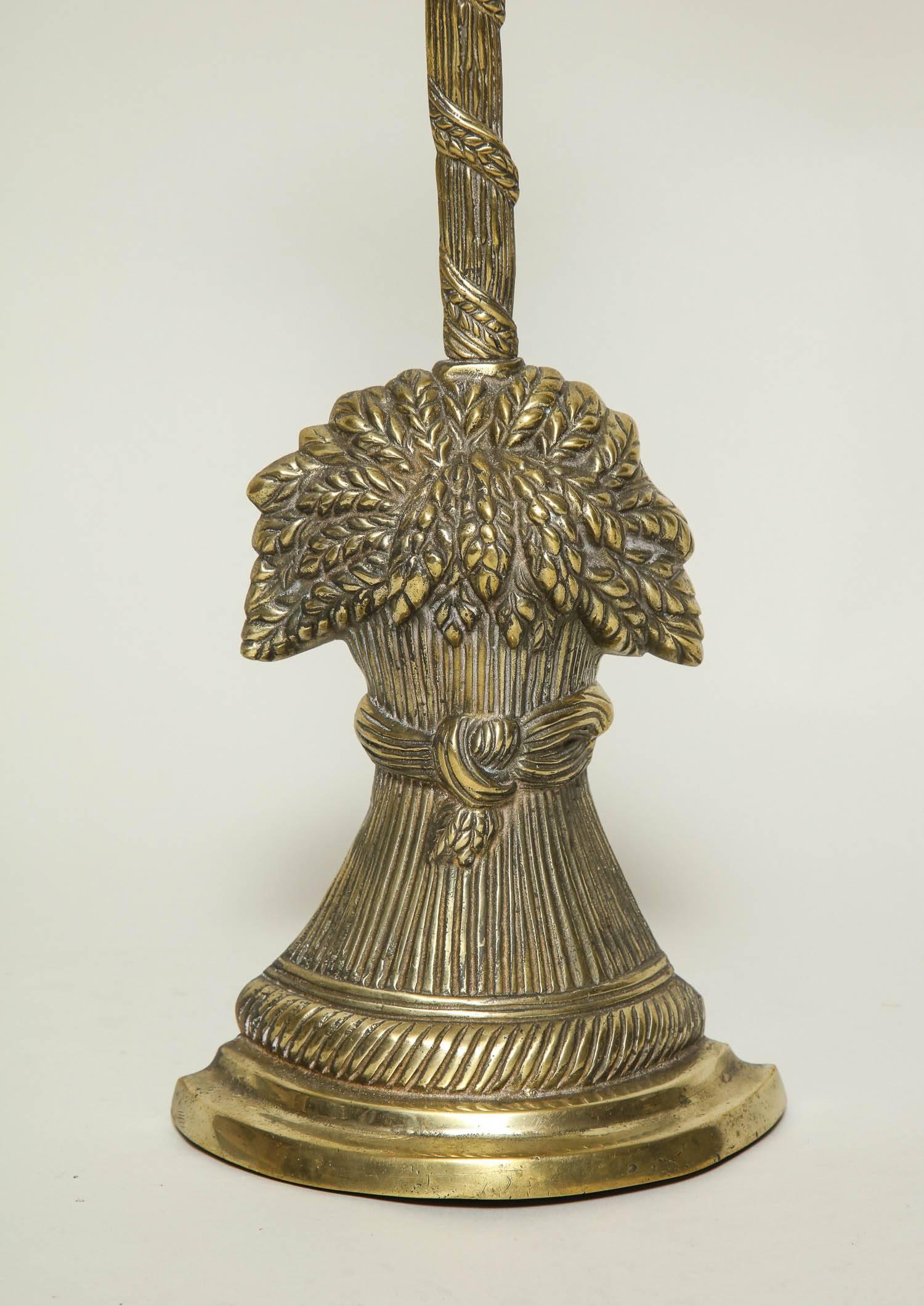 English 19th century brass doorstop with high handle (great for those who prefer not to bend all the way down to the ground) over bountiful sheaf of wheat base with rope twist border, the base with backfilled lead weight.