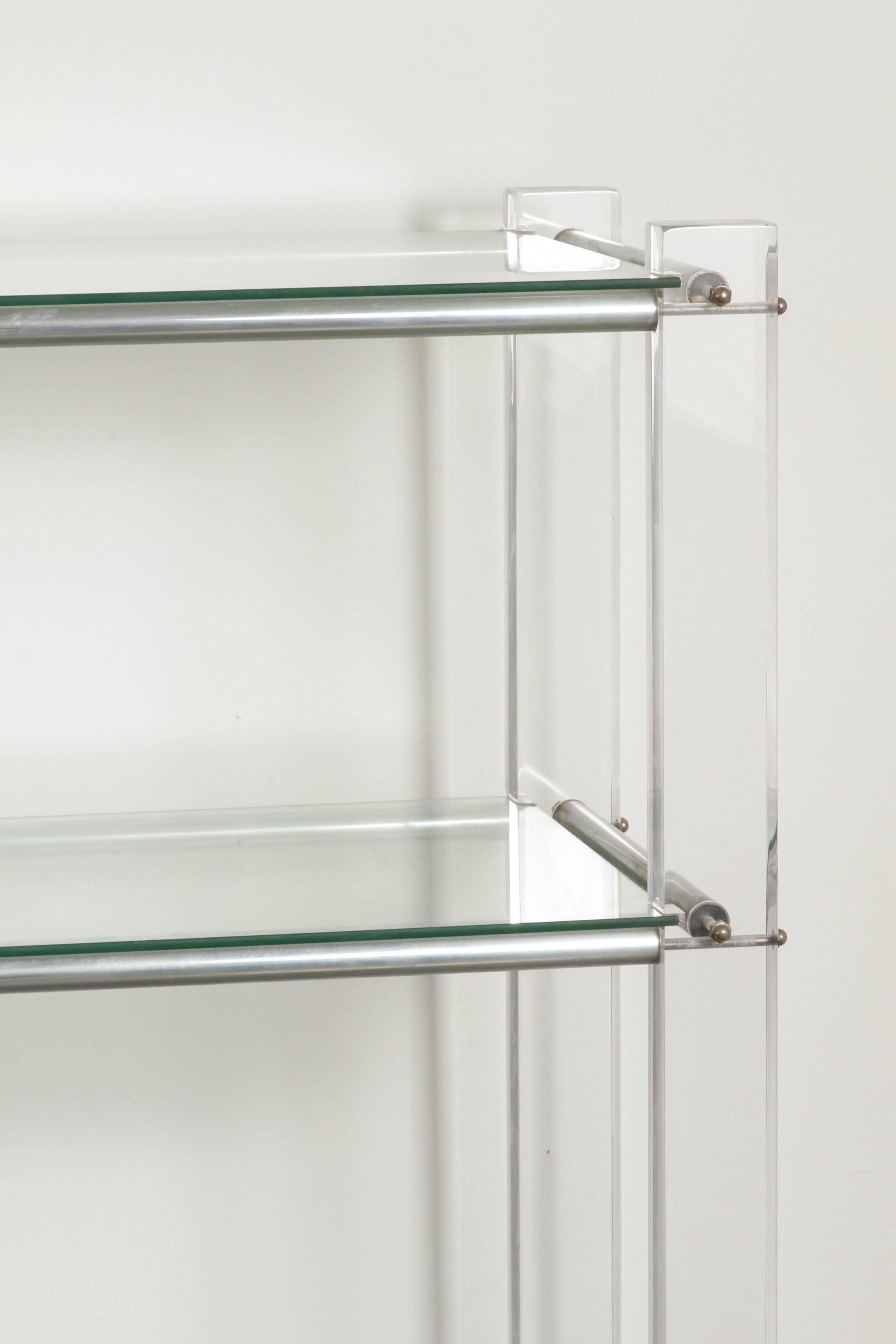 This seemingly gravity deifying four-tier bookcase features heavy glass shelving with Lucite and chrome base. Beautifully crafted.

 