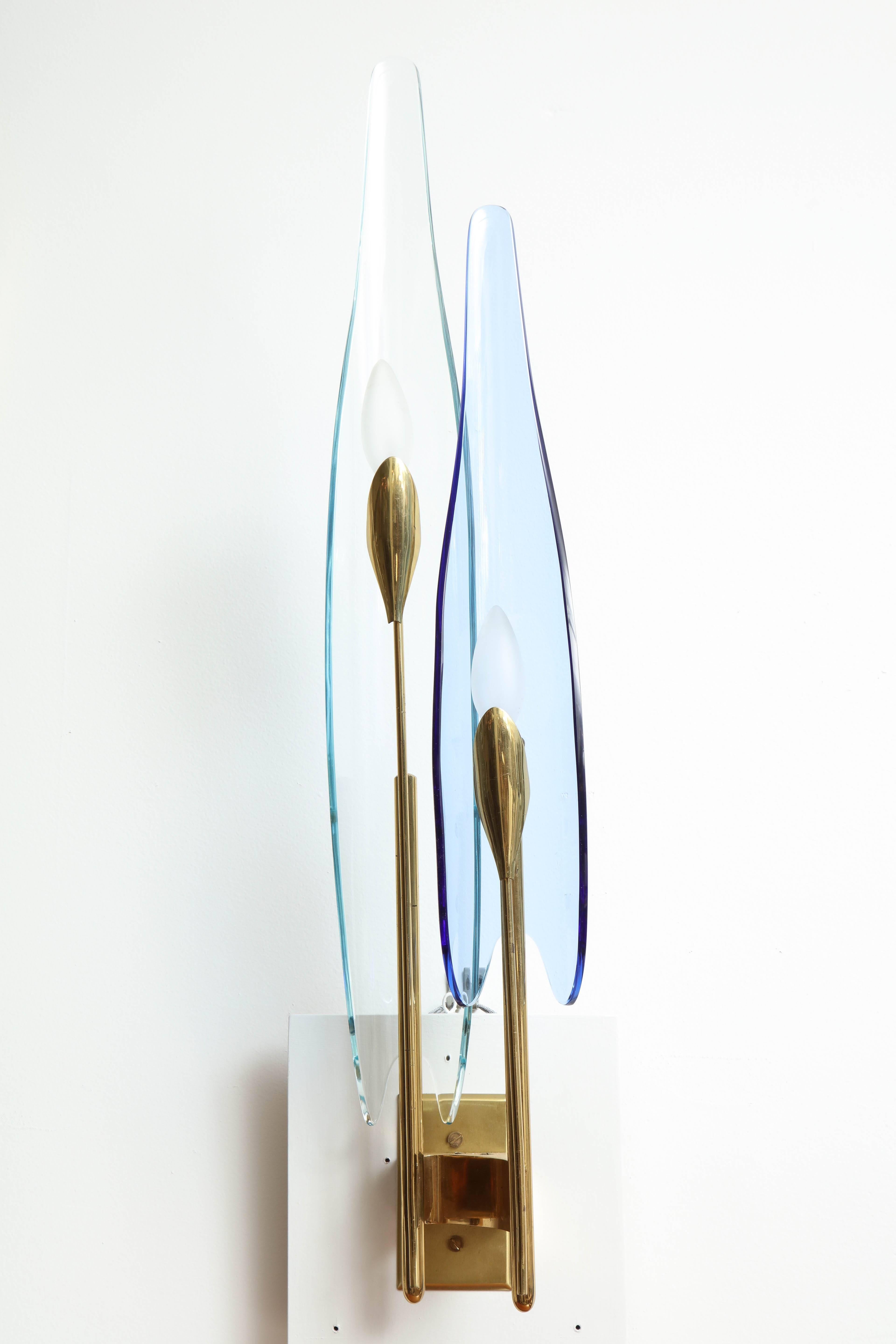 Pair of two-light Dahlia sconces by Max Ingrand for Fontana Arte. Fontana Arte model number 1461. Two-light sconces with elongated elements resembling floral petals, in blue and clear glass. Polished brass structures and newly made back plates for