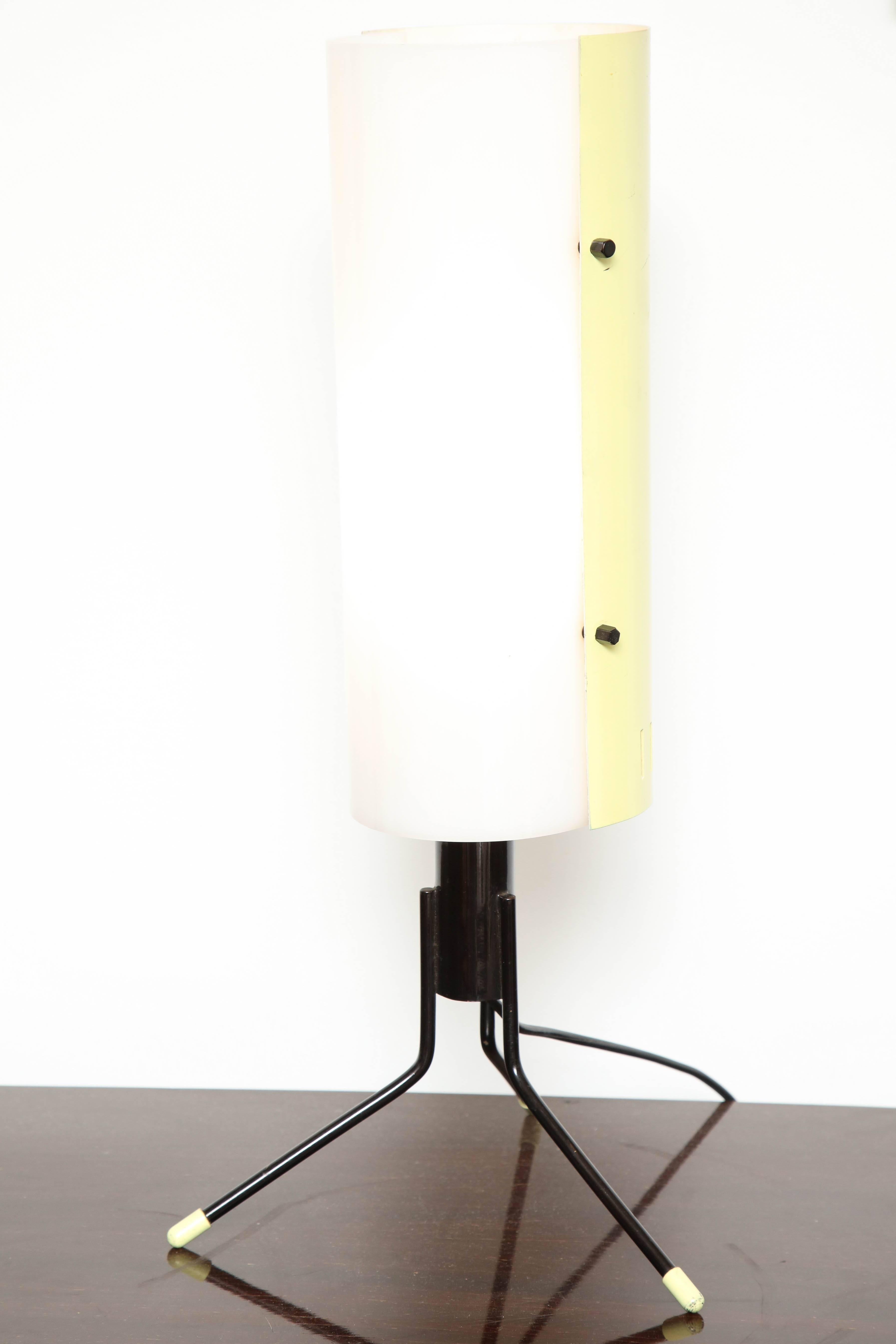 Futuristic Stilnovo table lamp made in Milan. The lamp shade has a cilinder combined from white plexiglass and yellow lacquer on iron tripod.
 
Stilnovo was a small Italian design and lighting manufacturer formed in the late 1940’s by Bruno Gatti,