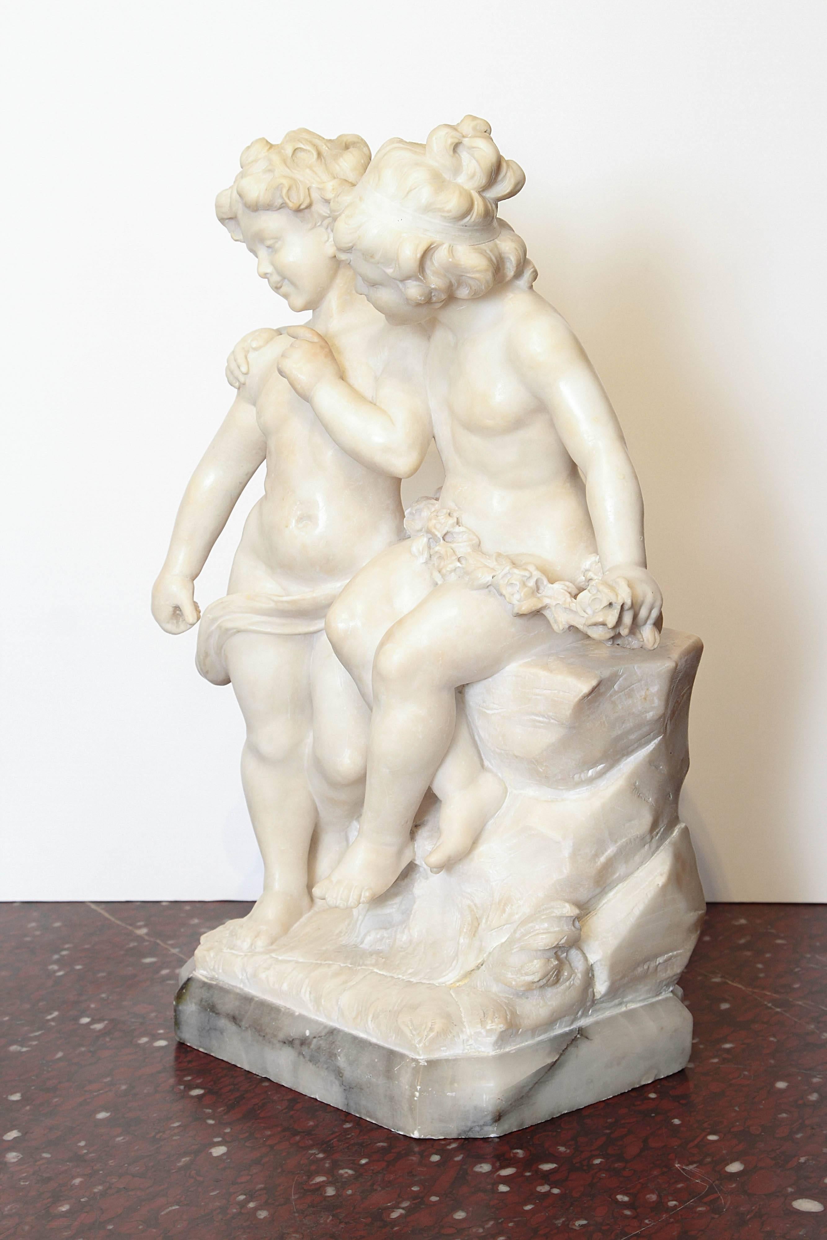 Finely cared 19th century Italian Carrara marble sculpture of two children playing on a stone garden wall.
