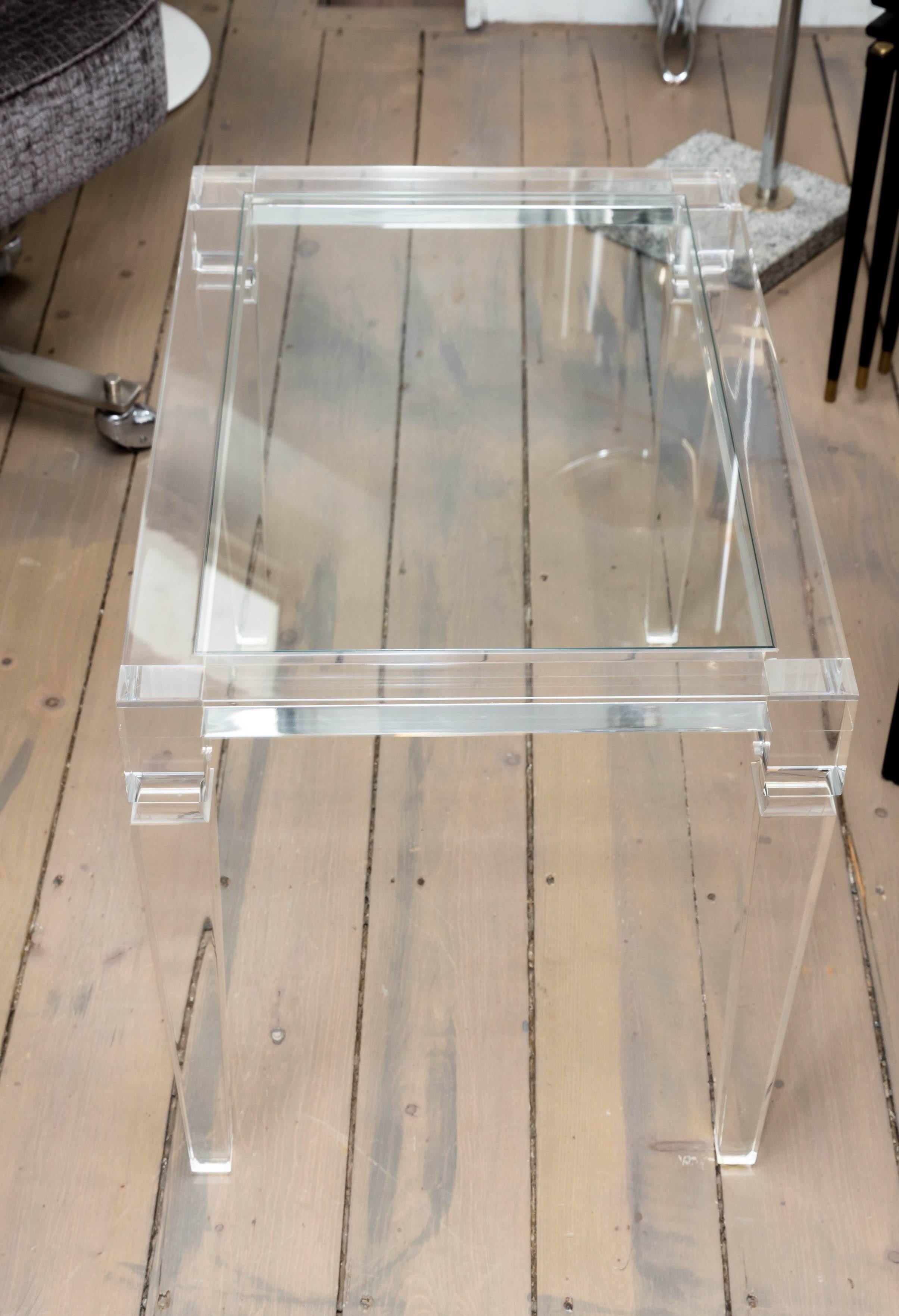 Rectangular Lucite glass top side table with tapered legs.
