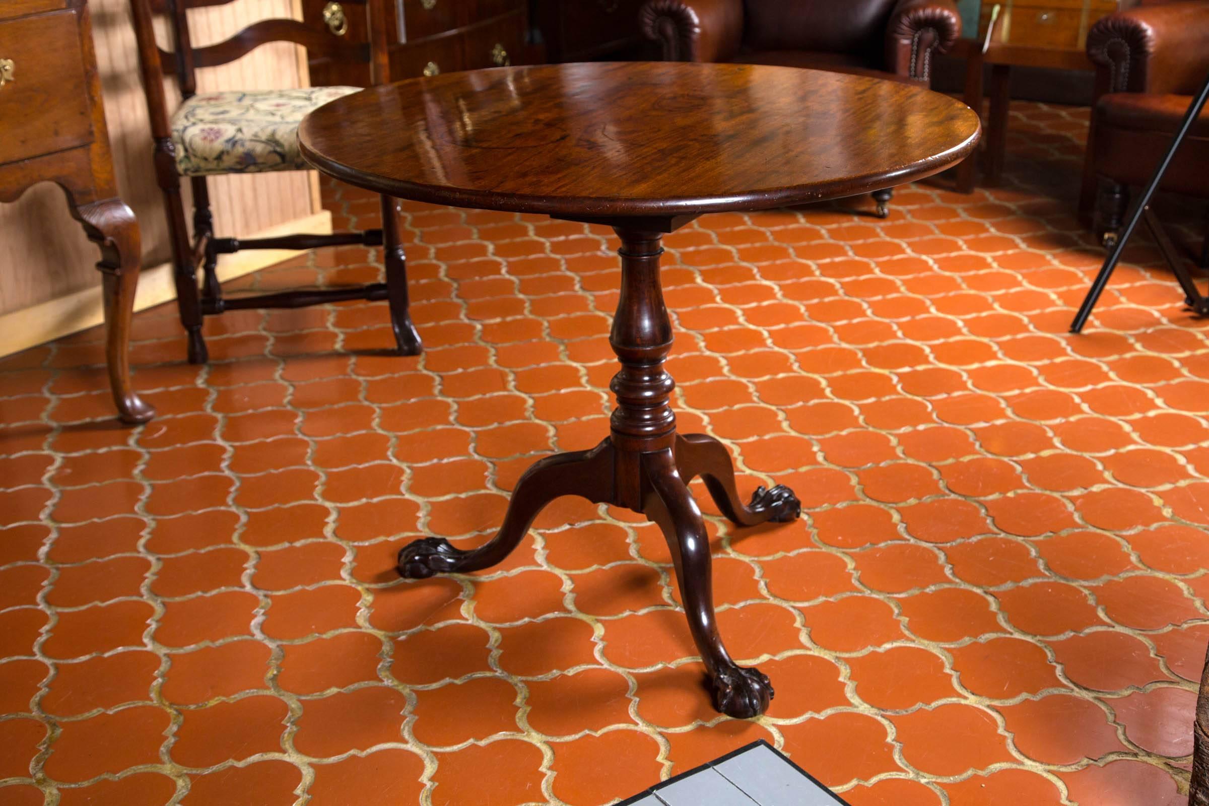 Excellent example of a solid mahogany tilt-top side table with good color and an aged patina. Raised on well turned. Carried by a tripod of well formed cabriole legs terminating in ball and claw feet.