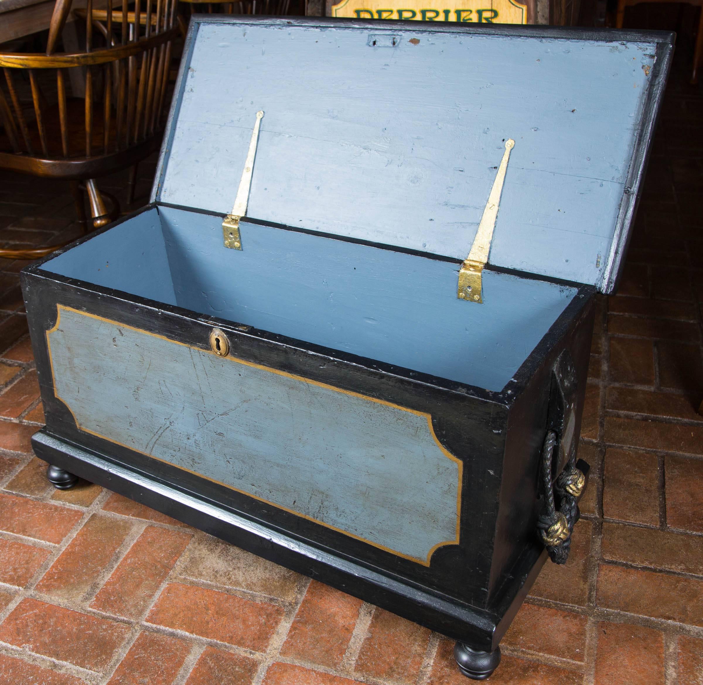 Painted 19th century seaman's chest resting on bun feet.
