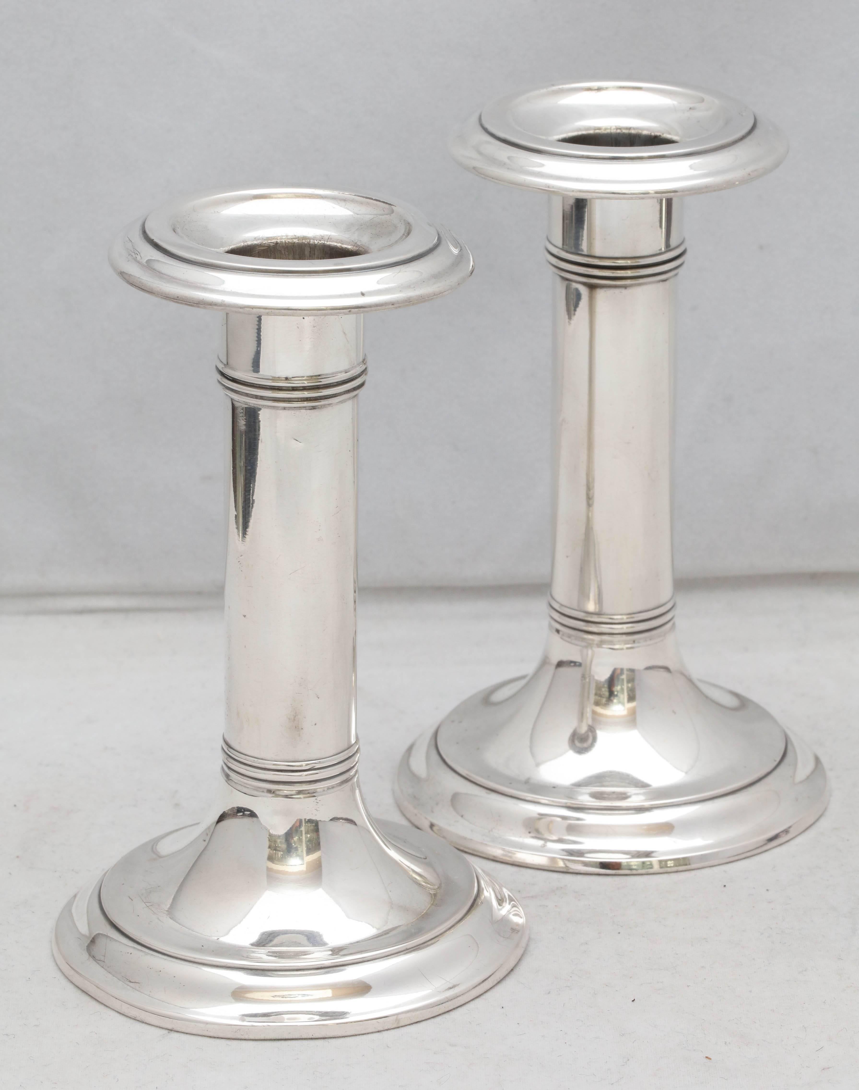 Pair of sterling silver, Edwardian candlesticks, The Gorham Mfg. Co., Providence, Rhode Island, circa 1905. Measure: 5 1/4 inches high x 3 1/4 inches diameter across base. Weighted column. Dark spots in photos are reflections. Excellent condition.