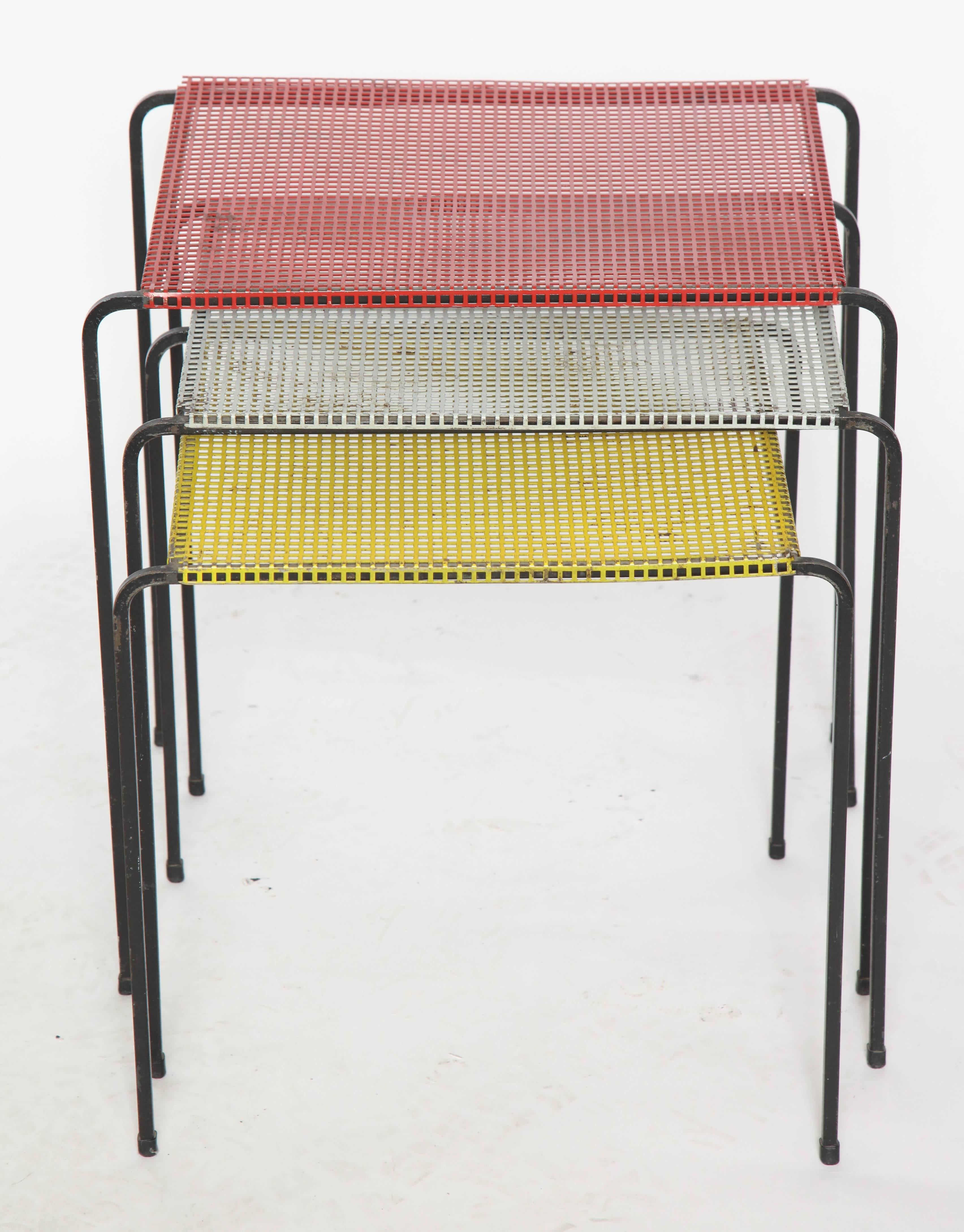 Suite of three nesting tables attributed to Mategot crafted of pierce metal in different colors with black iron legs France 1950s.