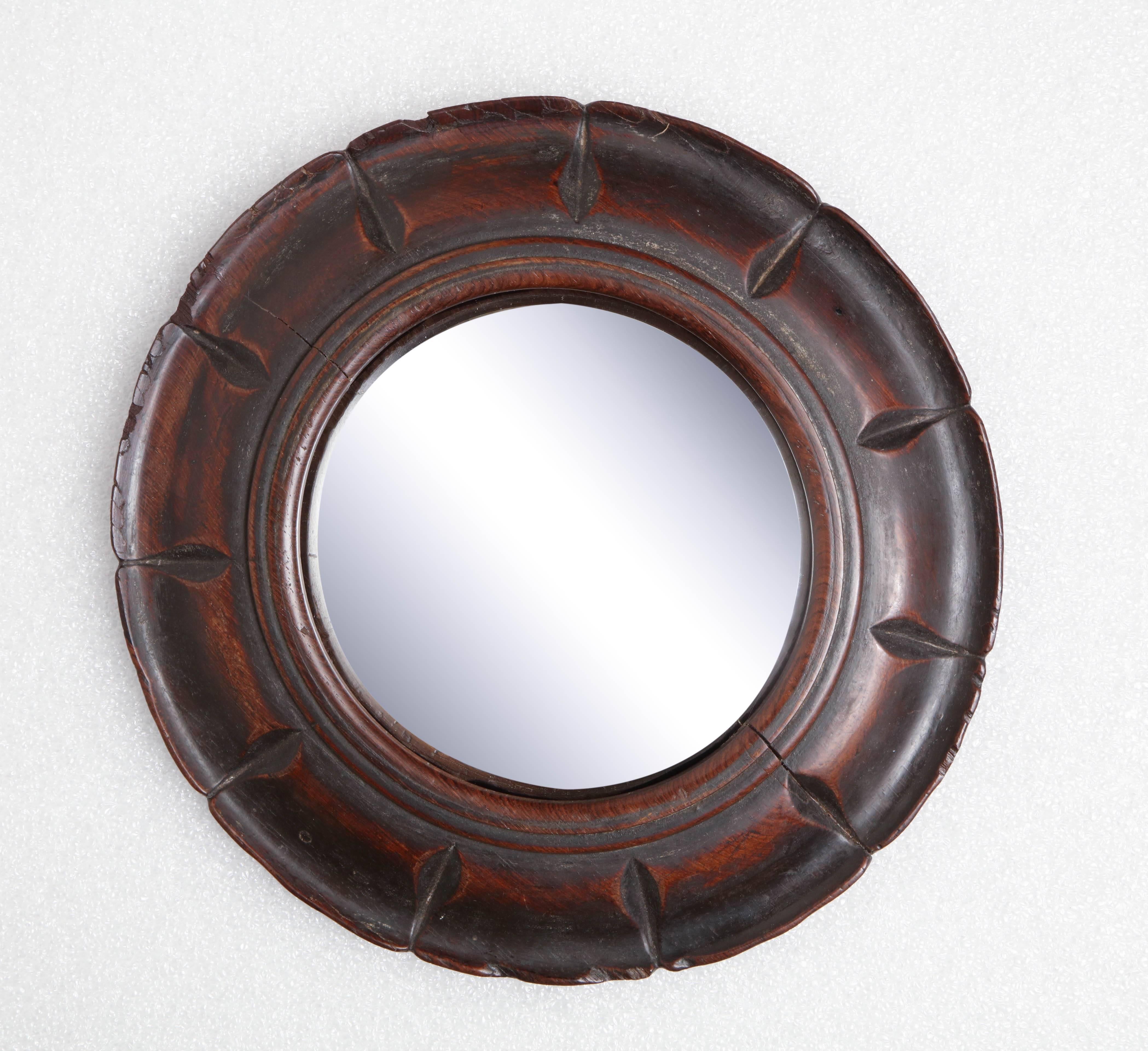 19th century English, convex mirror in a carved wooden frame.