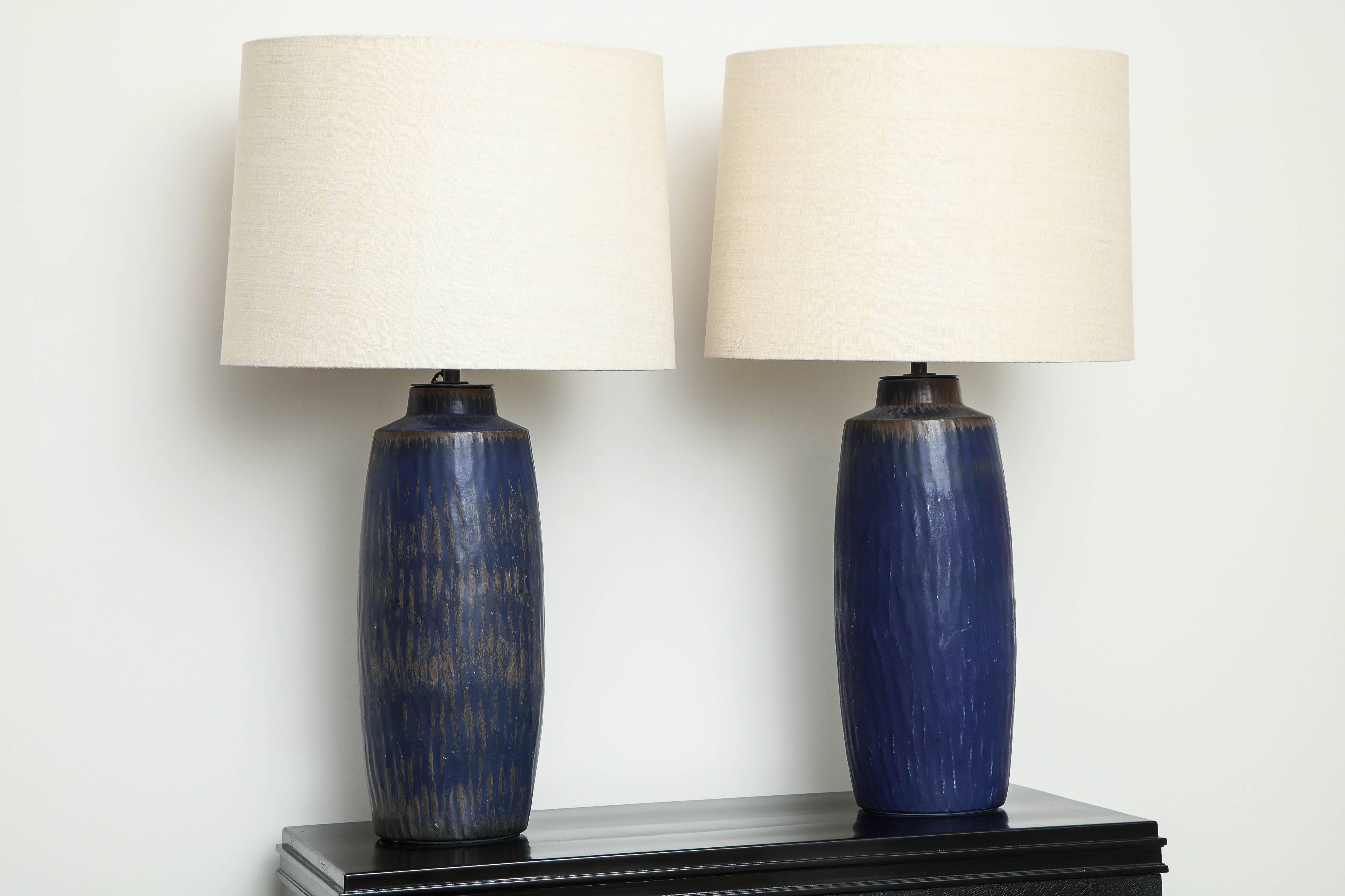 Unique pair of ceramic lamps from Rörstrand Studio, Sweden, circa 1950 by Gunnar Nylund. Made of stoneware, brand new shades and current wiring. Signed with artist marks. 

Gunnar Nylund (Swedish 1904-1997)
Pair of Ceramic Lamps, Rörstrand
