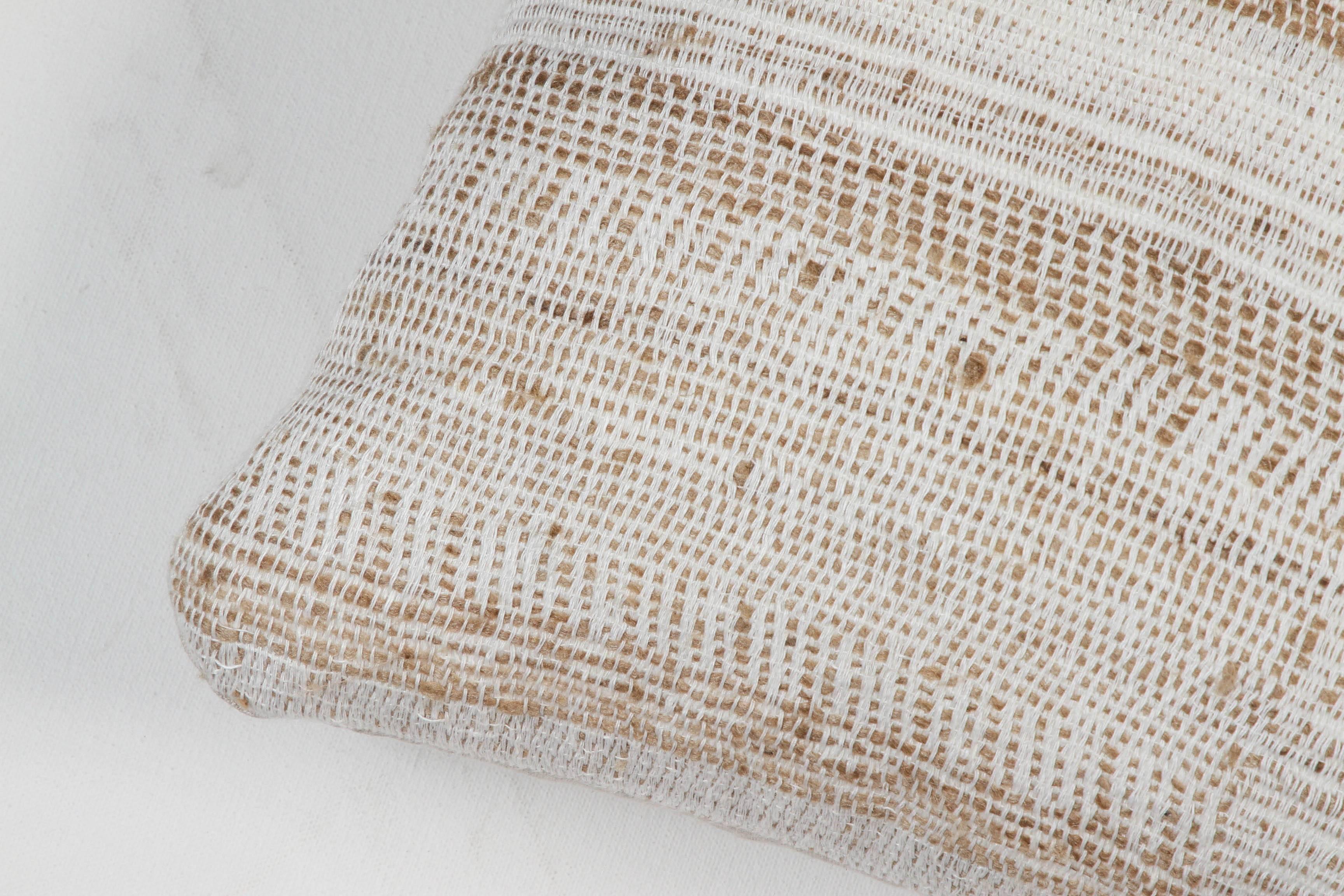 A contemporary line of cushions, pillows, throws, bedcovers, bedspreads and yardage hand woven in India on antique Jacquard looms. Handspun wool, cotton, linen, and raw silk give the textiles an appealing uneven quality.

This wool and raw tussar